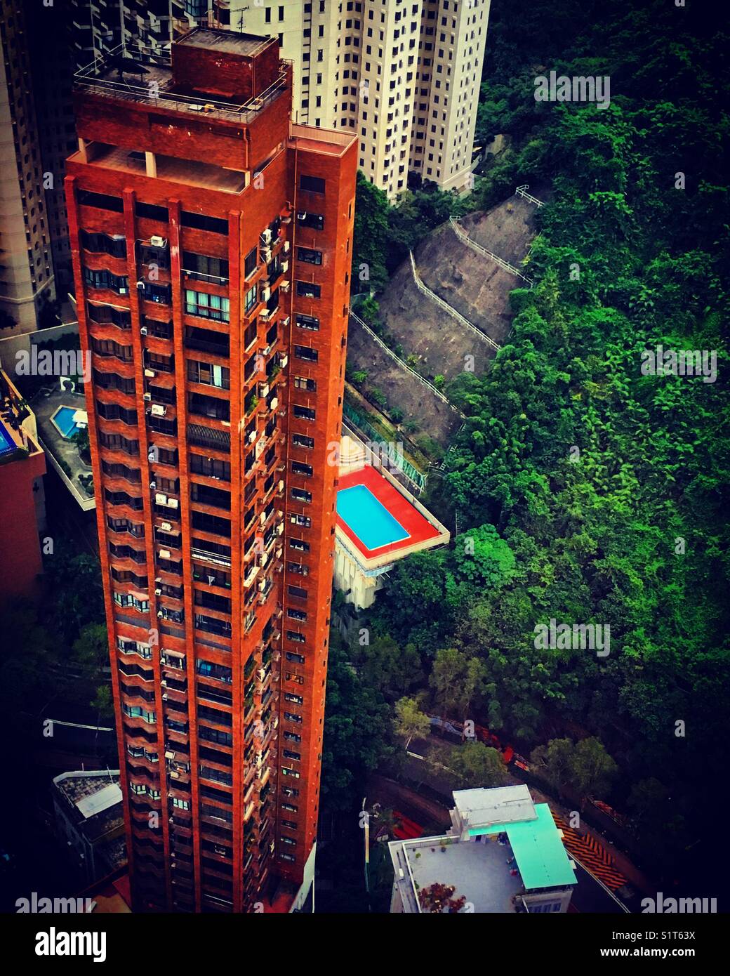 Seimming pool behing a tower in Hong Kong island - Smartphone Captured Stock Image