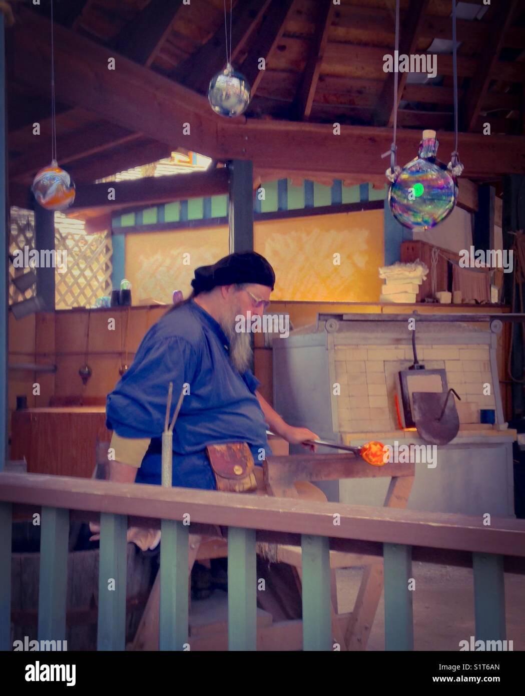 Glassblower making case at North Carolina Renaissance Festival 2017 - Smartphone Captured Stock Image