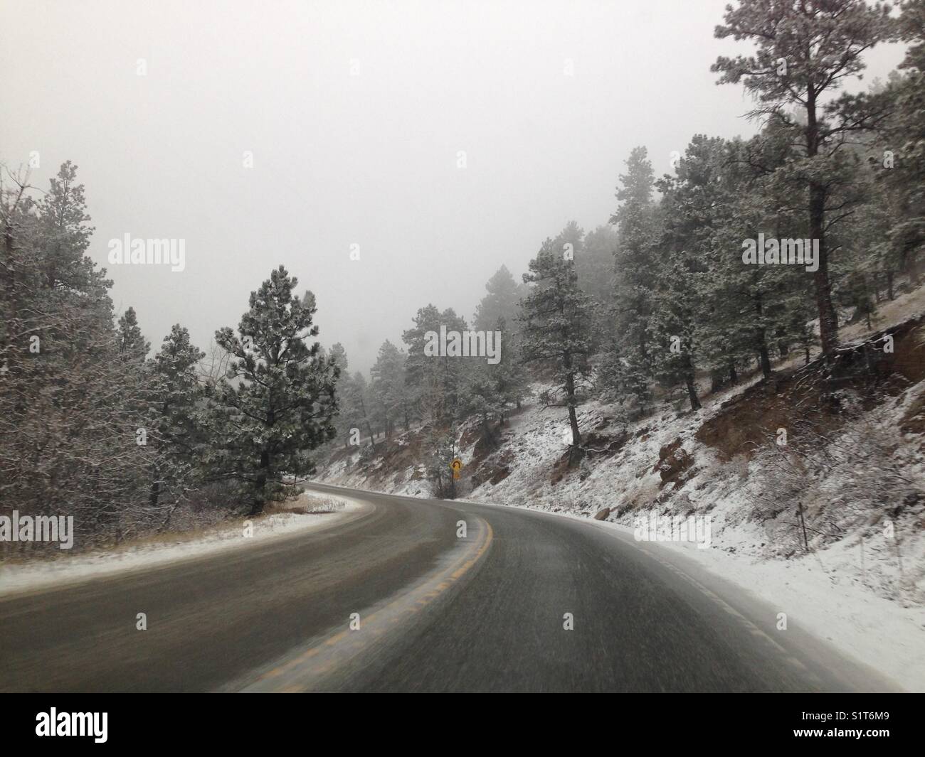 Snowy mountain road from car - Smartphone Captured Stock Image