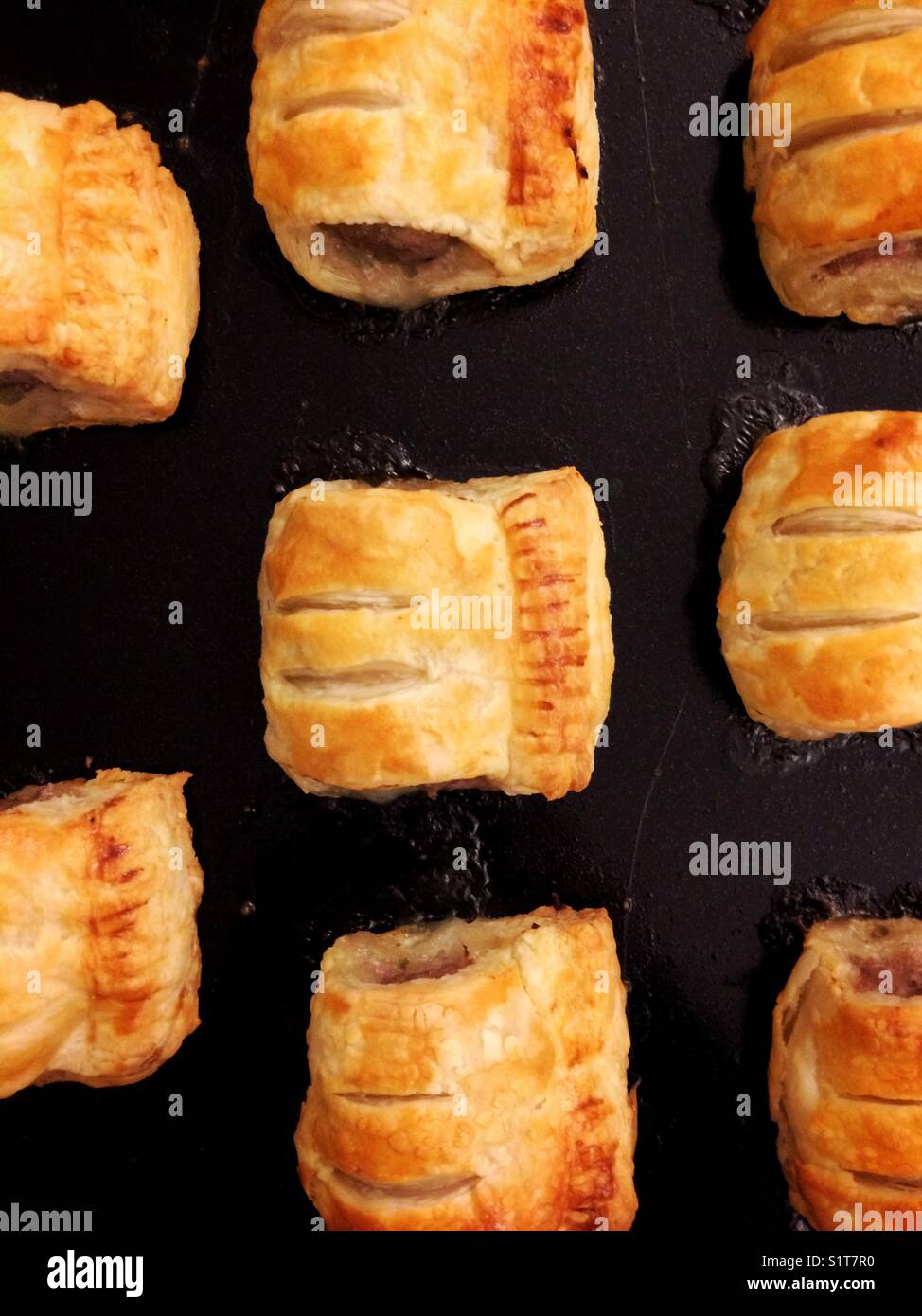 Eight sausage rolls on a baking tray - Smartphone Captured Stock Image