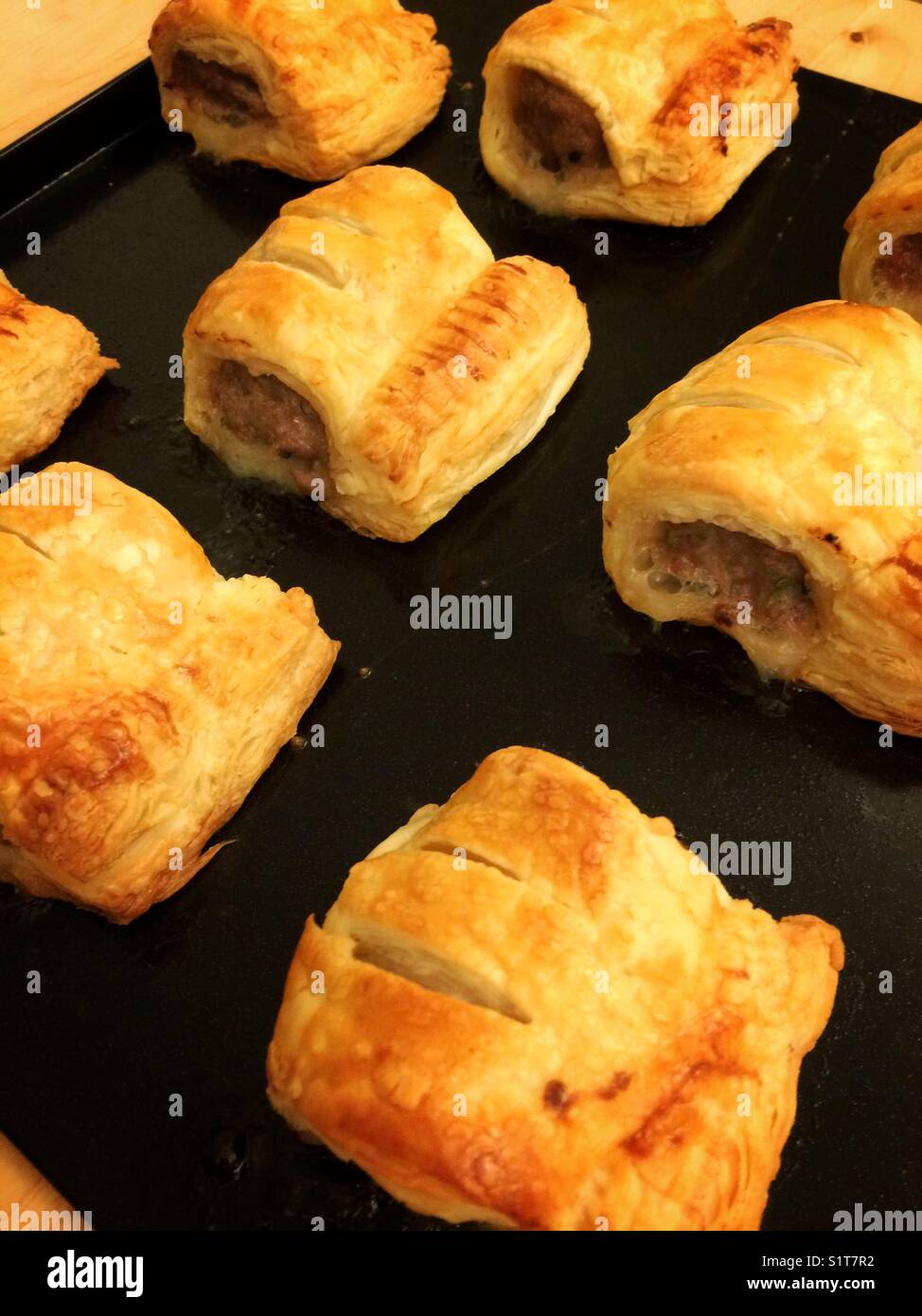 Eight baked sausage rolls on a baking tray - Smartphone Captured Stock Image