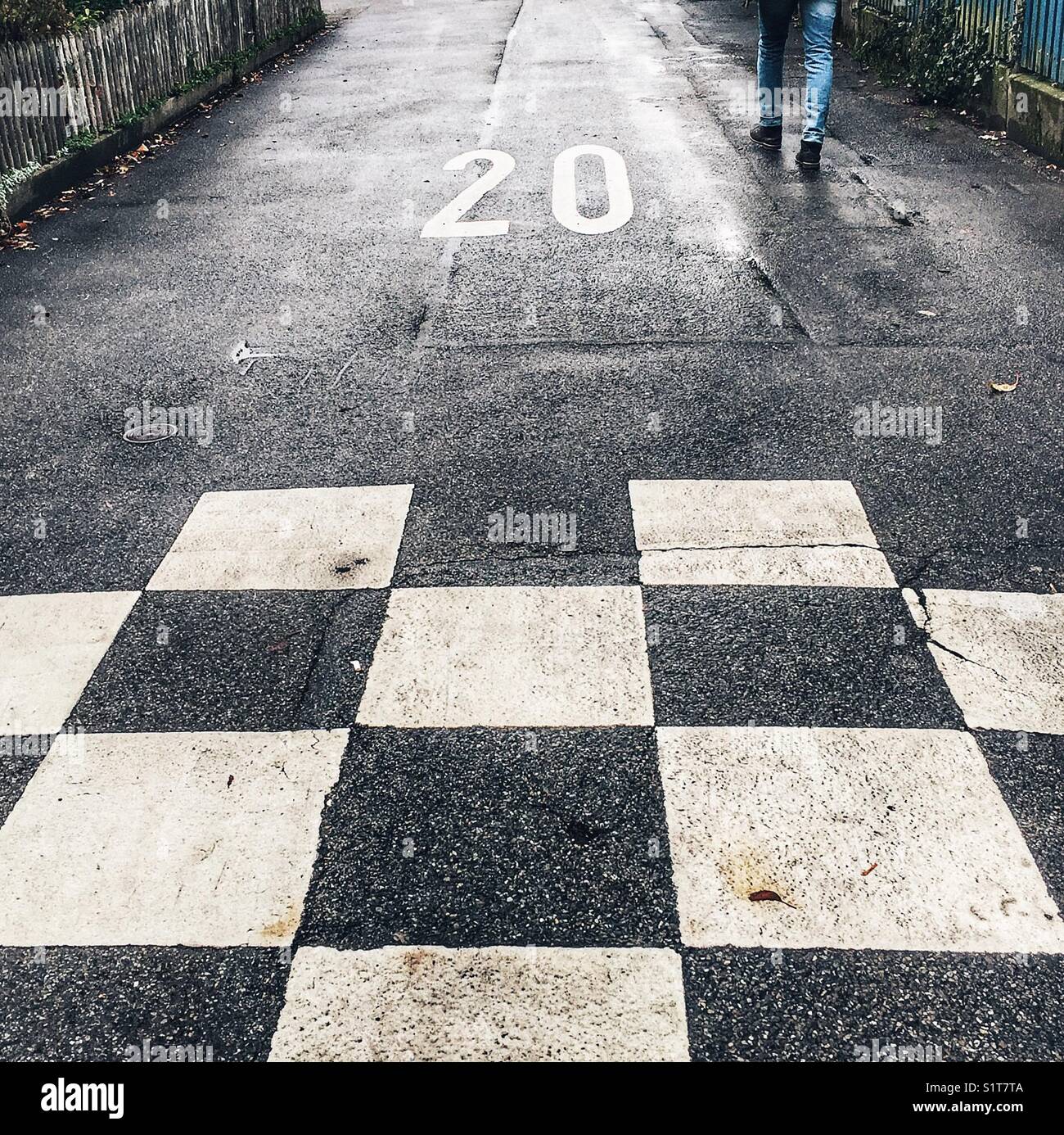 Checkered pattern on road with speed limit of 20 marked - Smartphone Captured Stock Image
