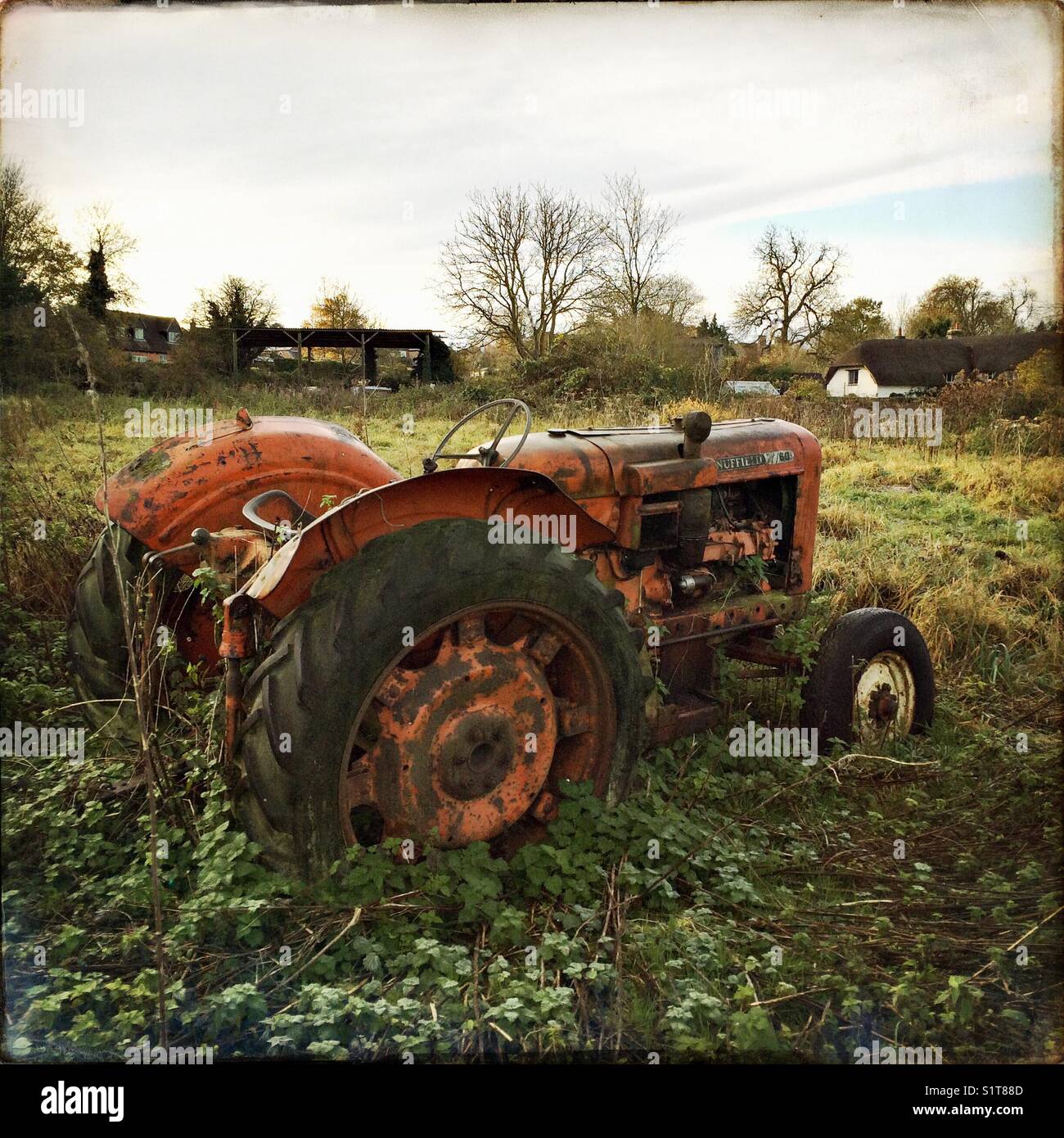 Tractor left to rust Stock Photo - Alamy
