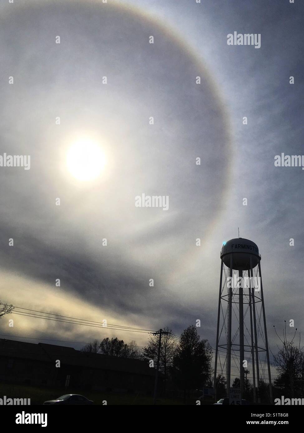 Water tower and sun with circular halo in Farmington, MO, United States