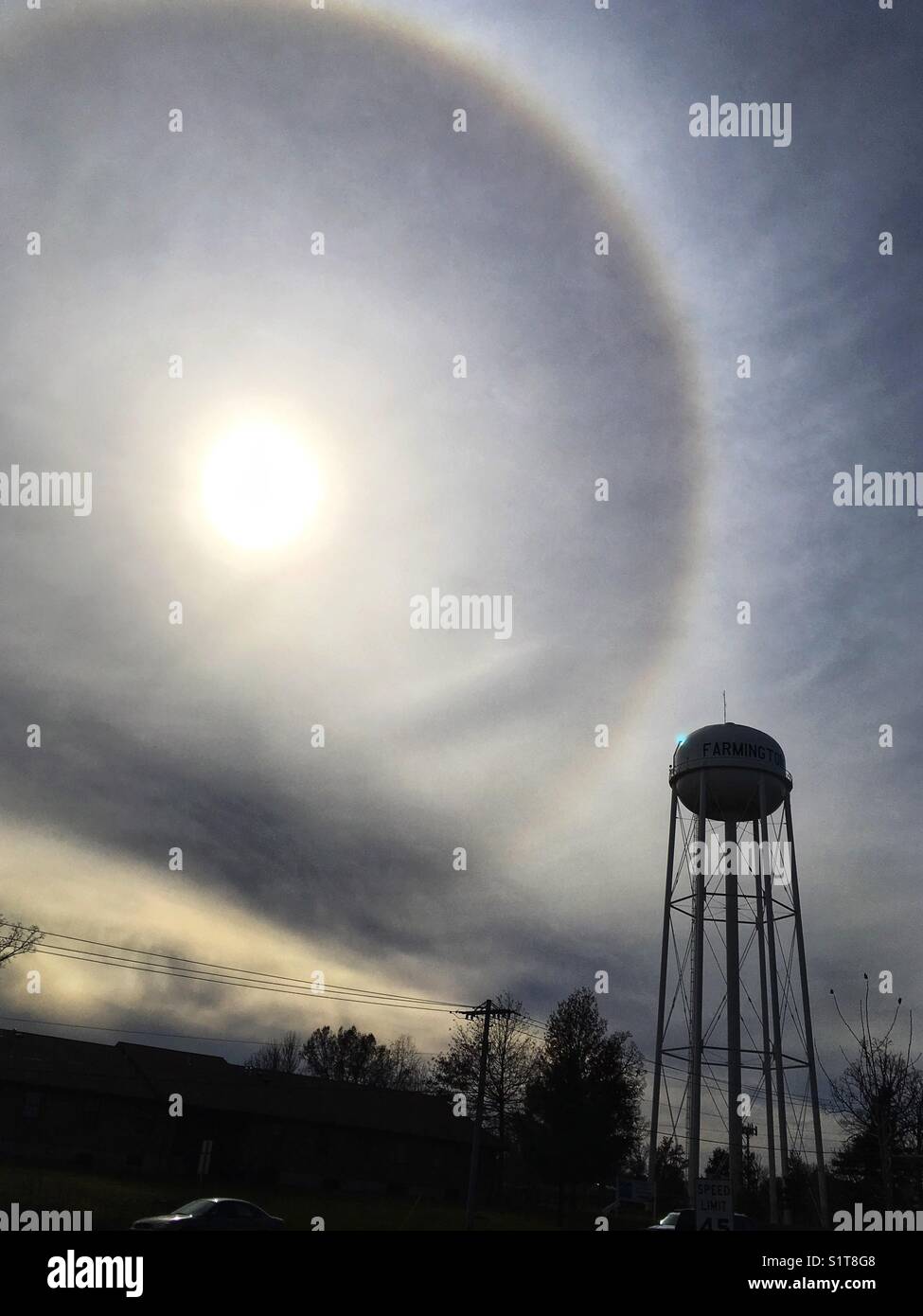 Water tower and sun with circular halo in Farmington, MO, United States. November 21, 2017. Stock Photo
