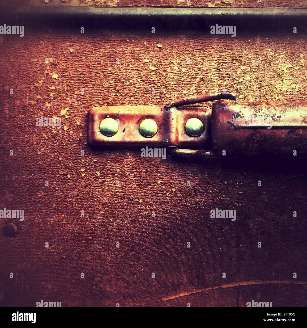 Rivets holding the handle of an old weathered suitcase - Smartphone Captured Stock Image