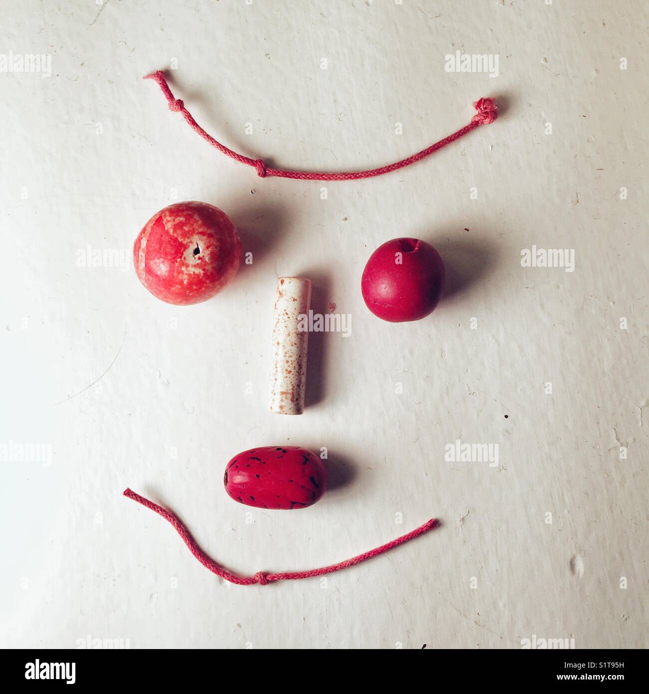 Modern jewelry making - face out of beads and cord - Smartphone Captured Stock Image