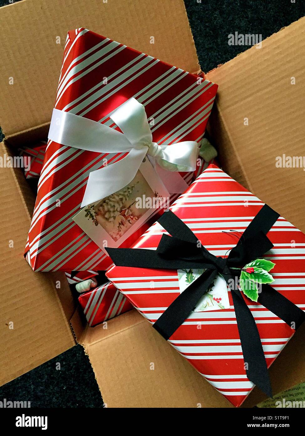 Wrapped Christmas presents sitting on top of a packing box, USA - Smartphone Captured Stock Image
