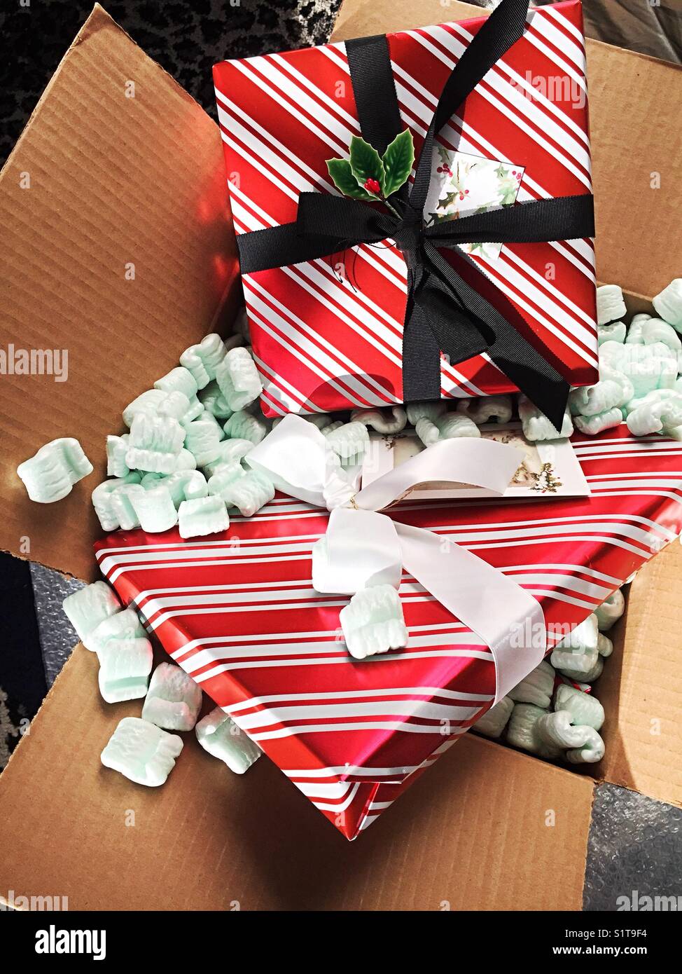 Wrapped Christmas presents and Styrofoam peanuts and packing box, USA - Smartphone Captured Stock Image