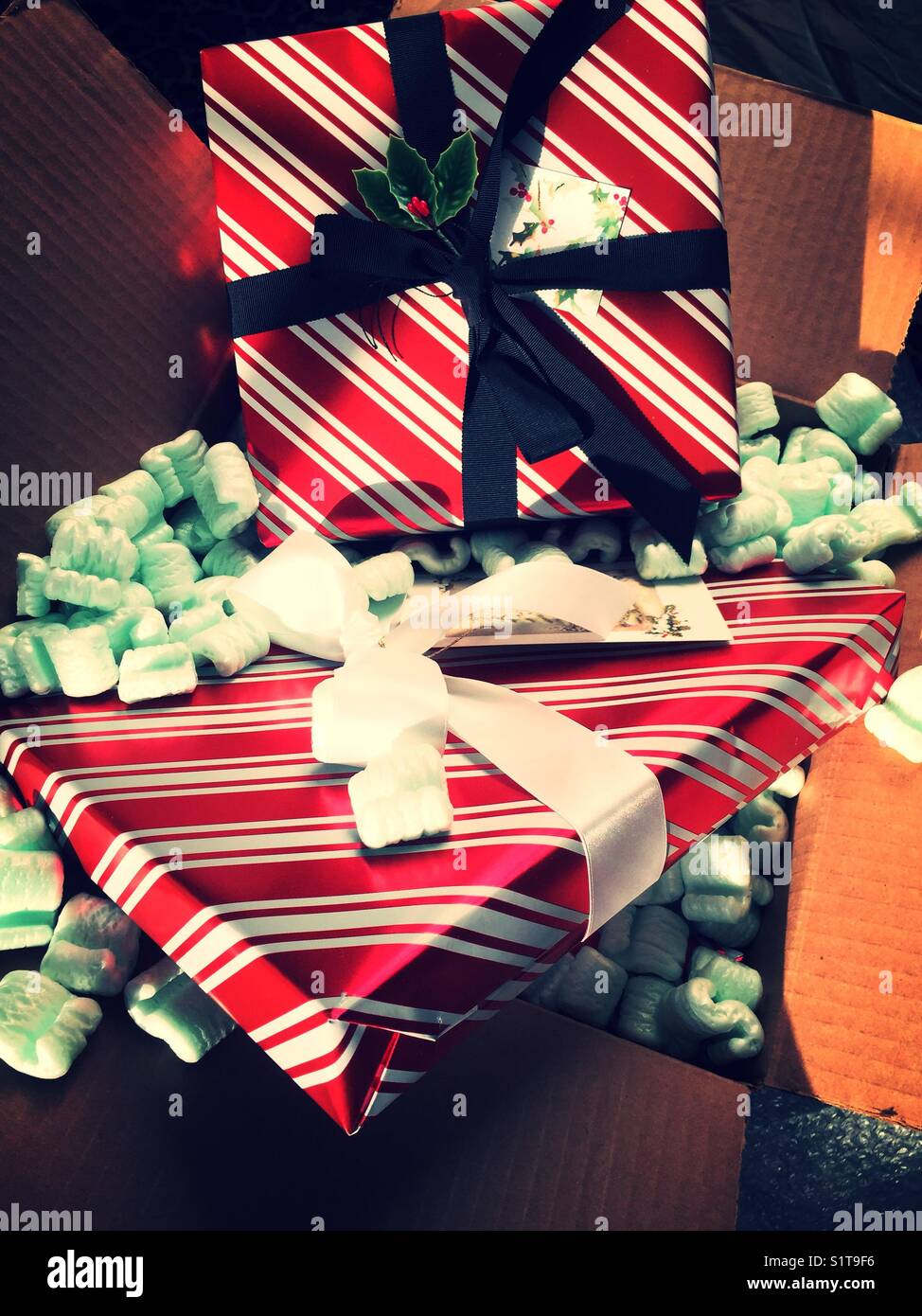 Wrapped Christmas presents in packing boxes with Styrofoam peanuts, USA - Smartphone Captured Stock Image