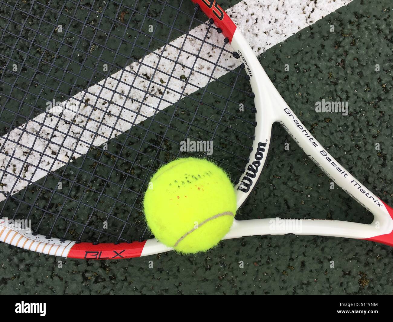 Tennis ball and racket on court Stock Photo Alamy