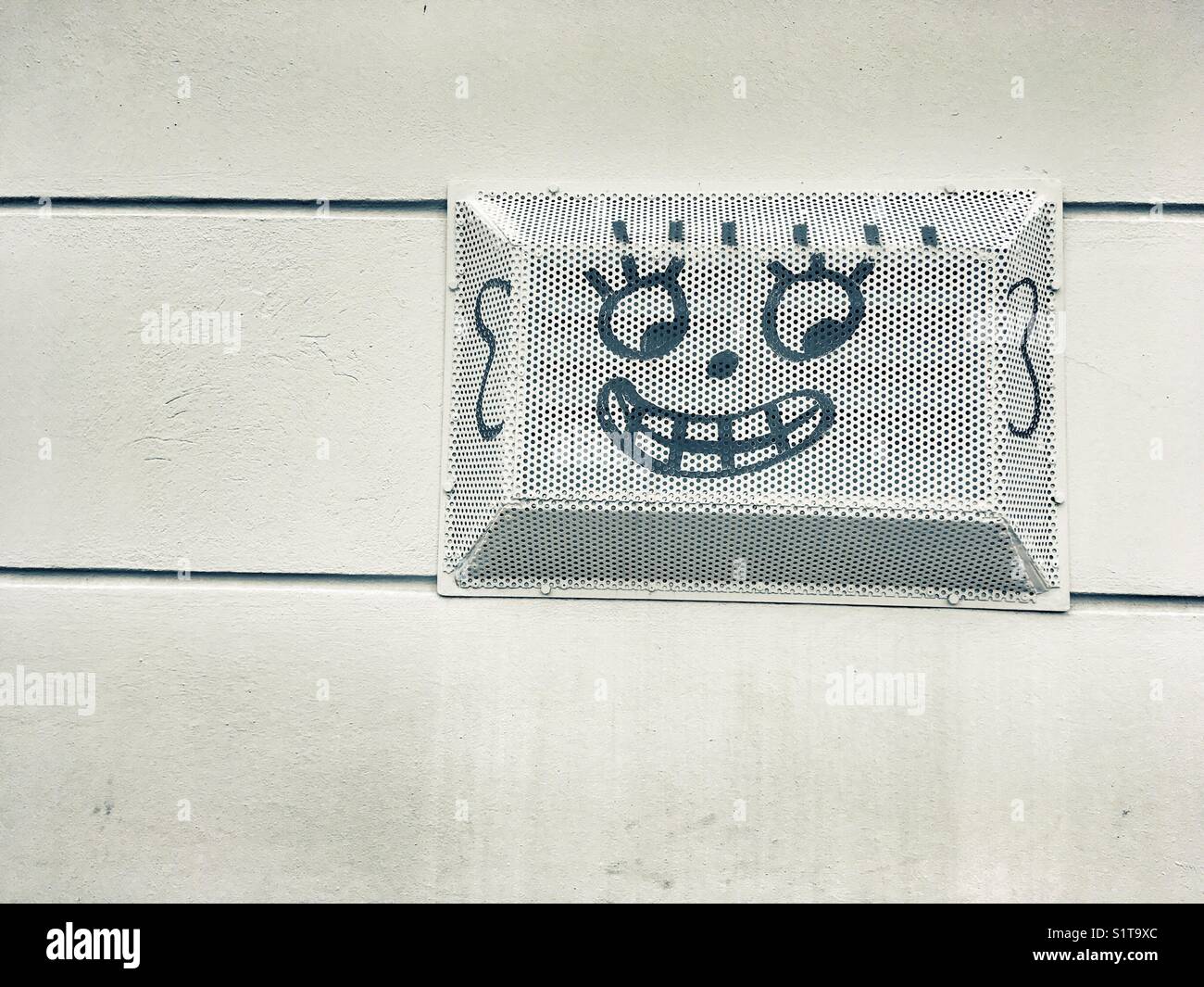 A smile drawn on a city wall - Smartphone Captured Stock Image