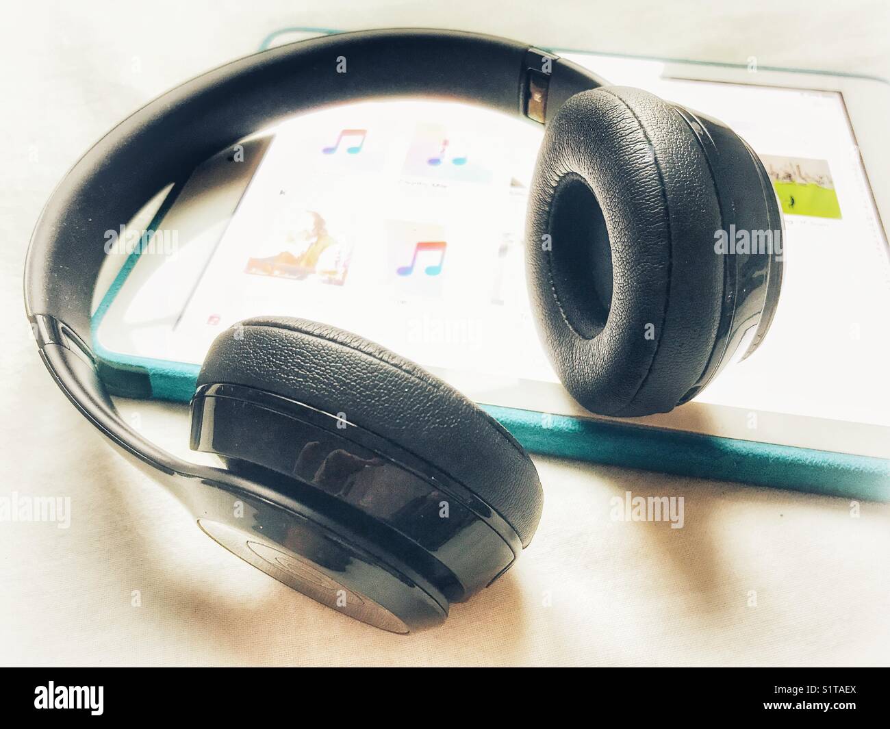 Beat over-ear headphones on top of an iPad - Smartphone Captured Stock Image
