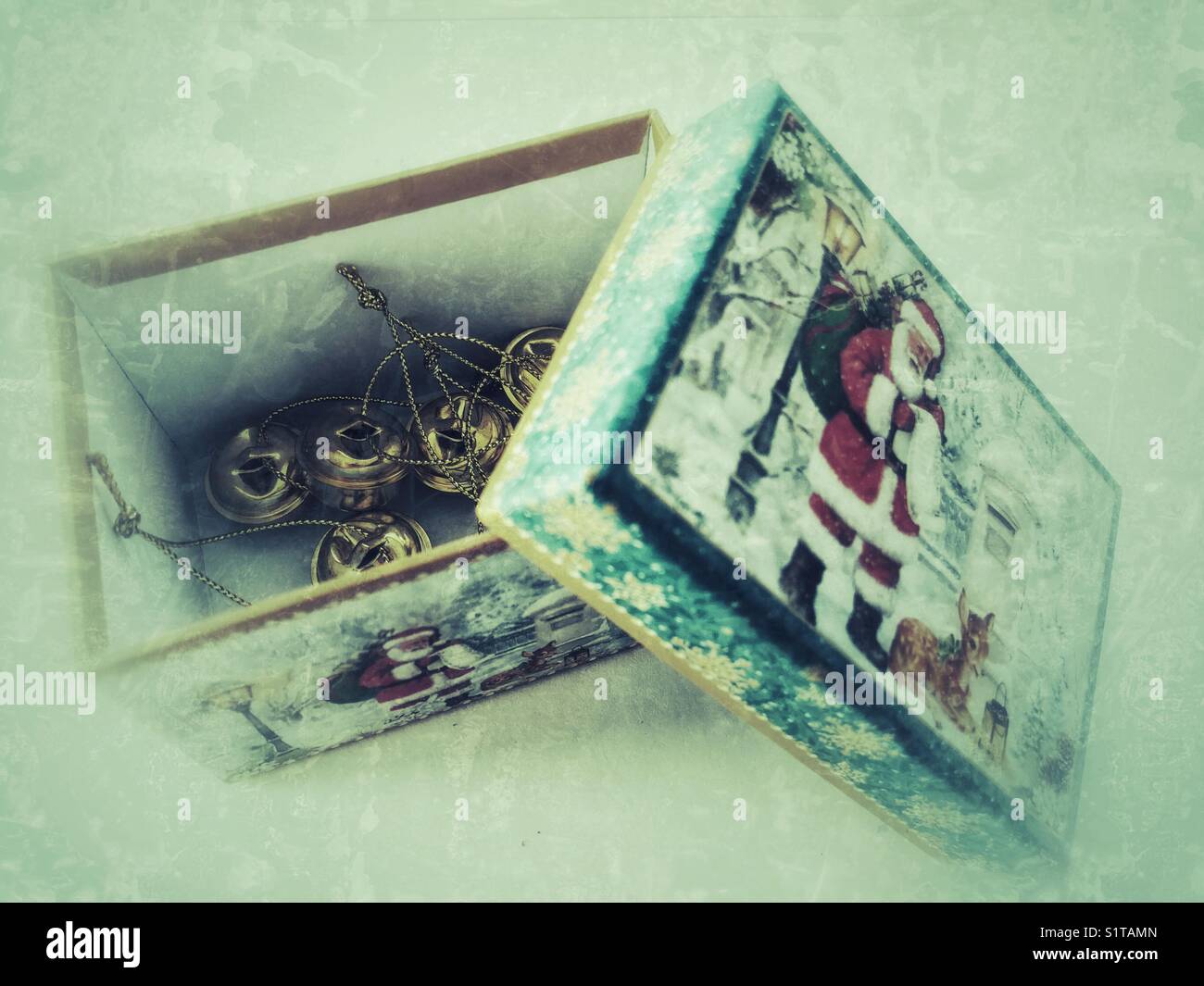 Christmas box with golden Christmas bell decorations inside - Smartphone Captured Stock Image