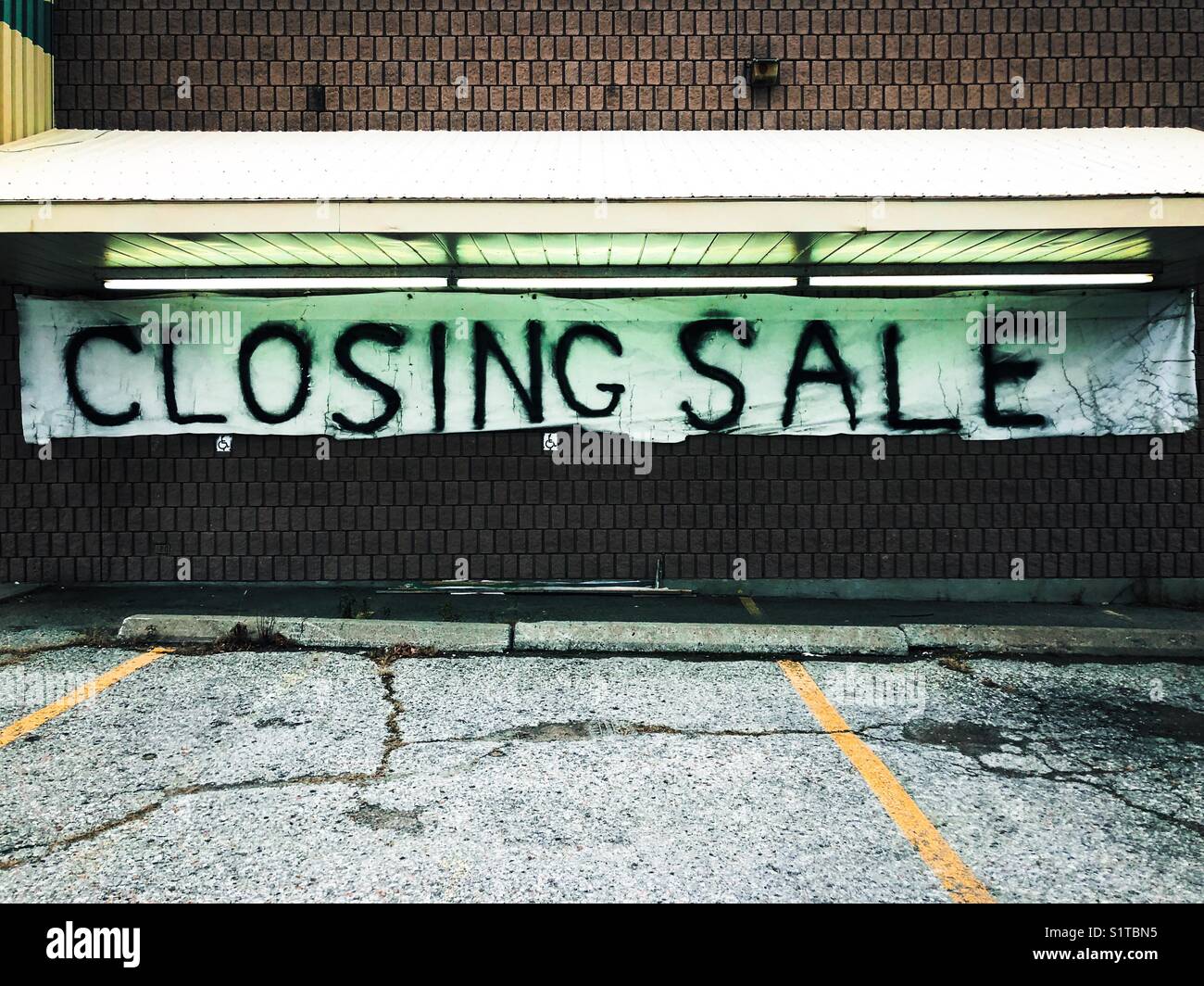 Spray painted sign that reads Closing Sale on a small town store brick building in Orono, Ontario, Canada - Smartphone Captured Stock Image Spray painted sign that reads Closing Sale on a small town store brick building in Orono, Ontario, Canada - Smartphone Captured Stock Image