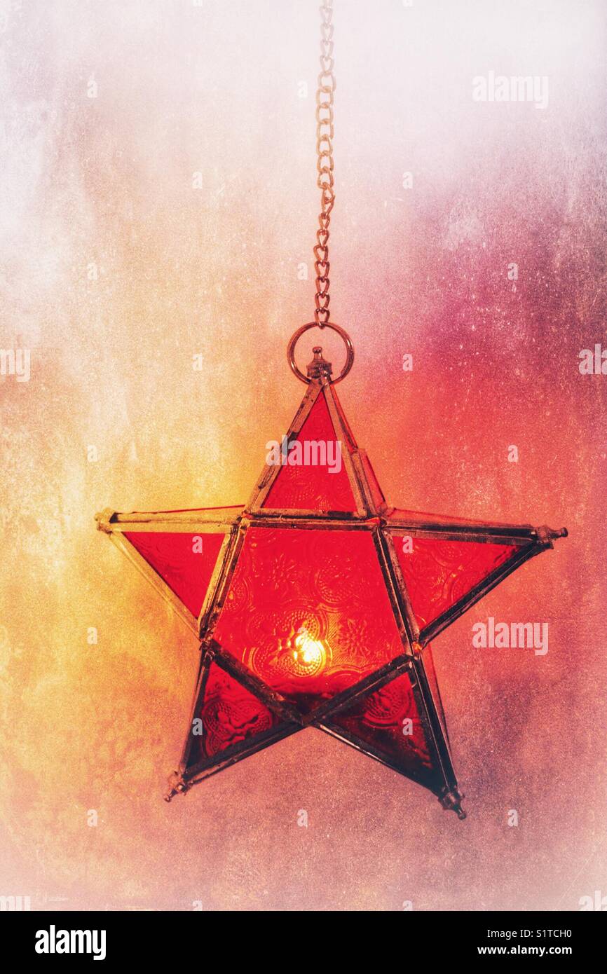Glass star candle holder, hanging from a chain - Smartphone Captured Stock Image