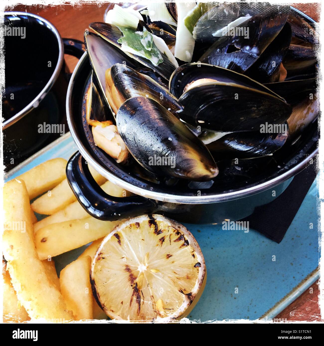 A bowl of mussels and chips Stock Photo Alamy
