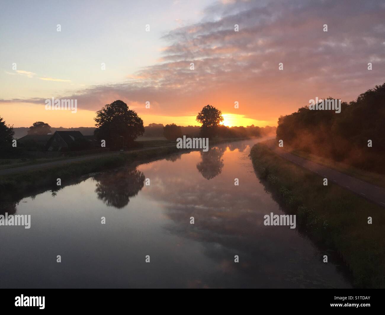 Looking at a canal during sunrise. Stock Photo