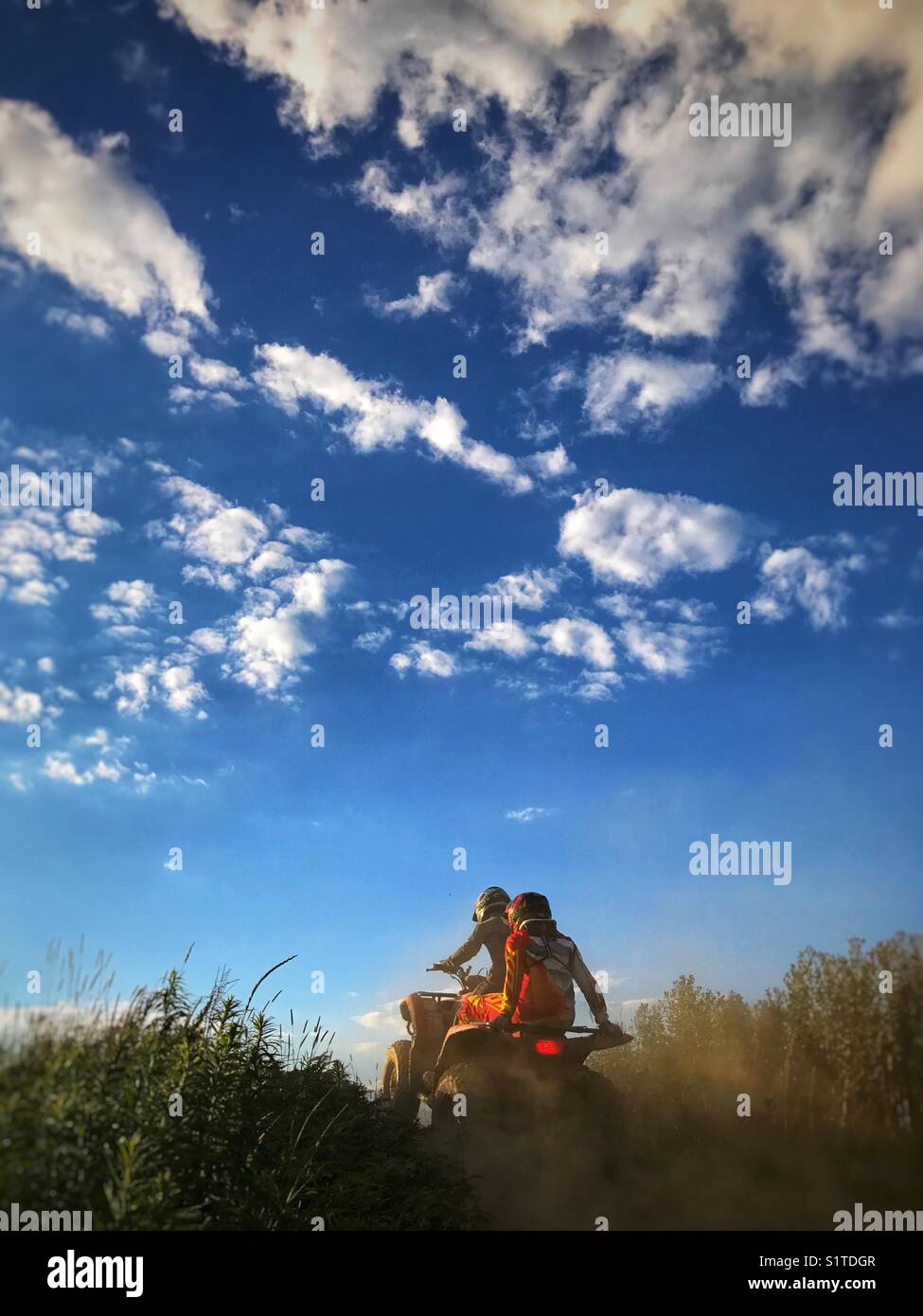 Two people on a 4-wheeler ATV - Smartphone Captured Stock Image