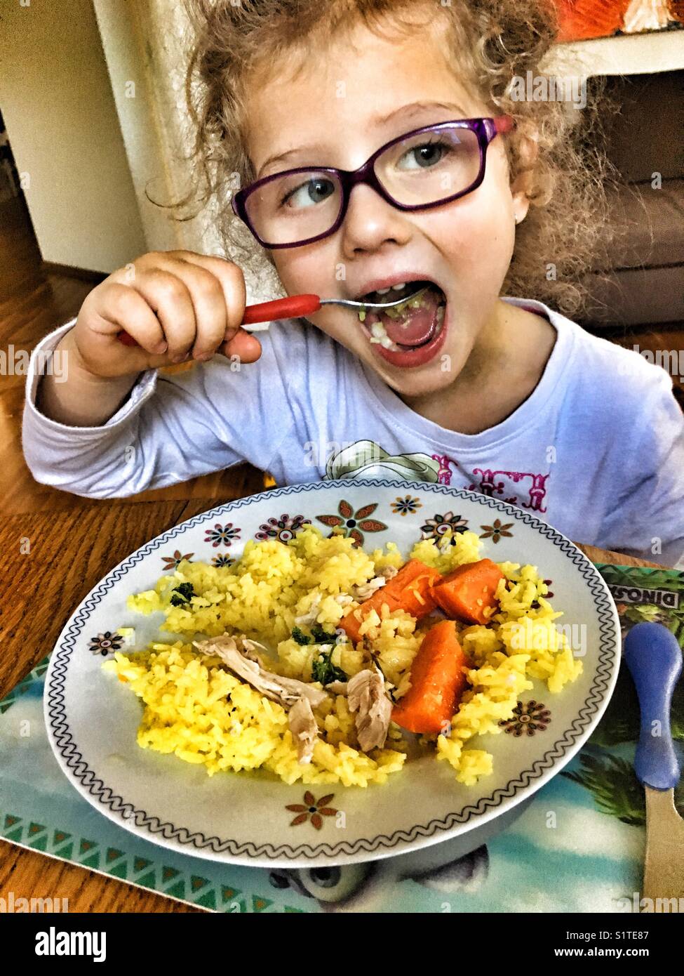 Four years old girl eats her lunch, child eating - Smartphone Captured Stock Image