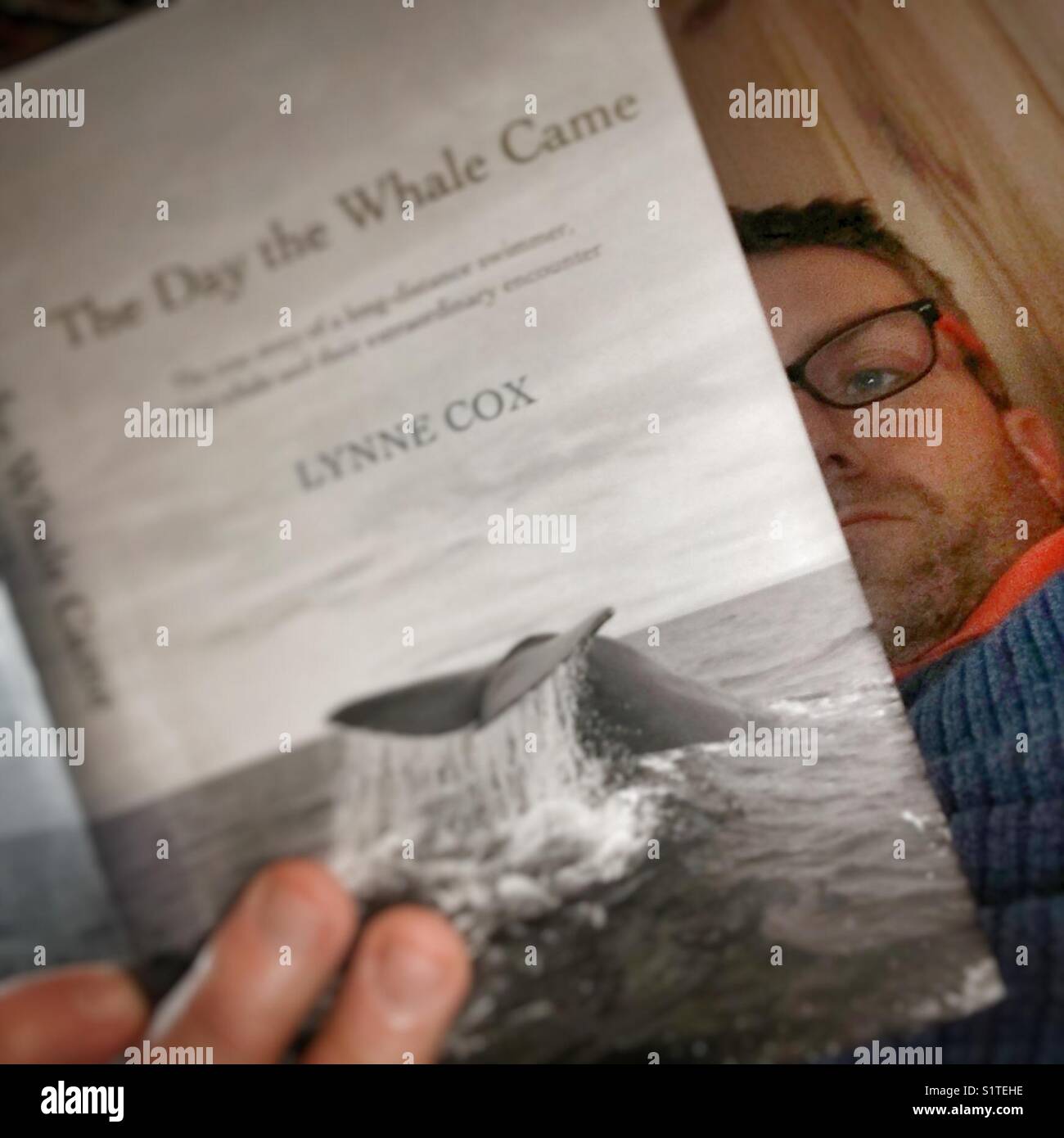 Selfie reading a book with a foto on the cover that I fotographed myself. Stock Photo
