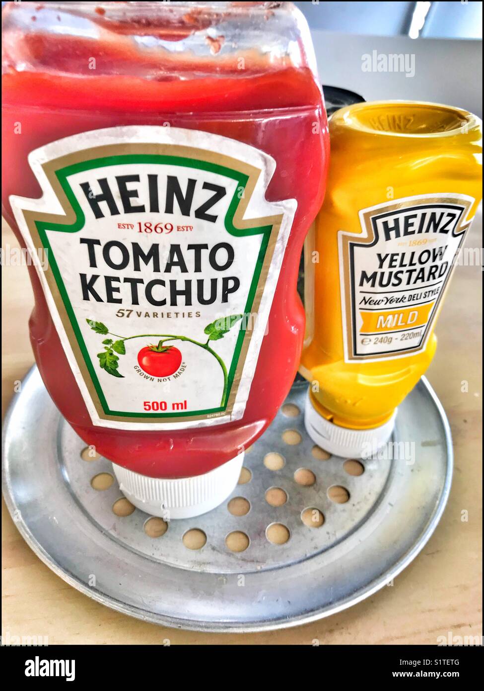 Heinz tomato ketchup and yellow mustard. - Smartphone Captured Stock Image