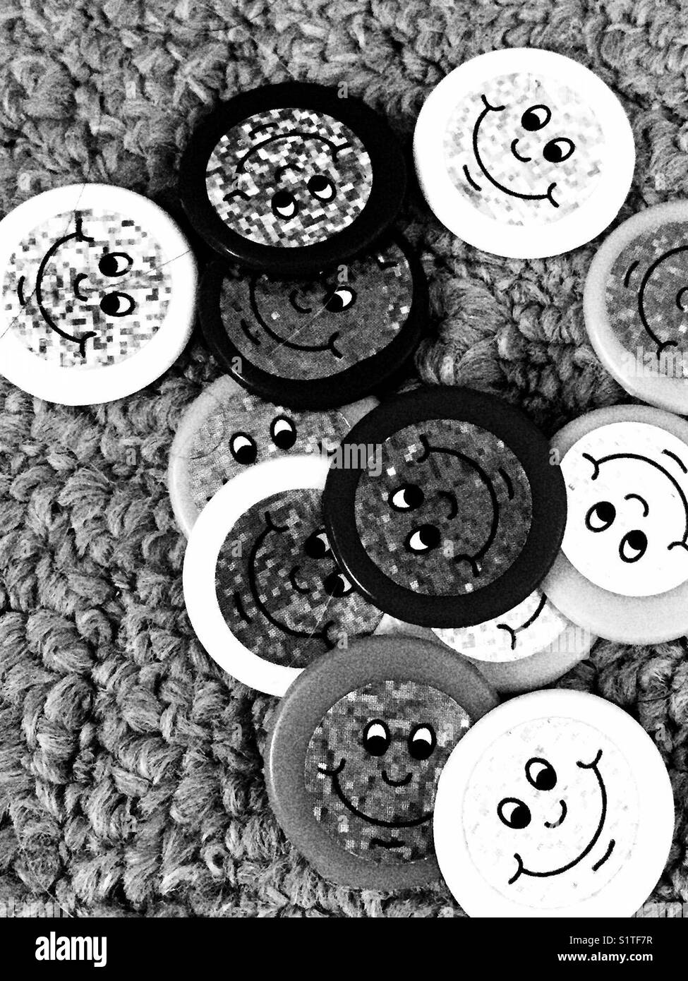 Smiley face counters on carpet Stock Photo