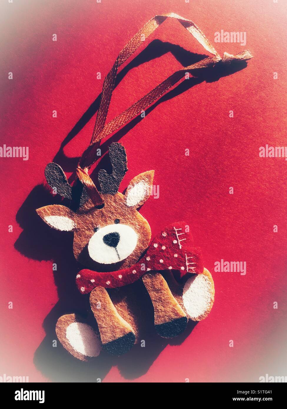 Christmas decoration, reindeer on a red background with copy space - Smartphone Captured Stock Image