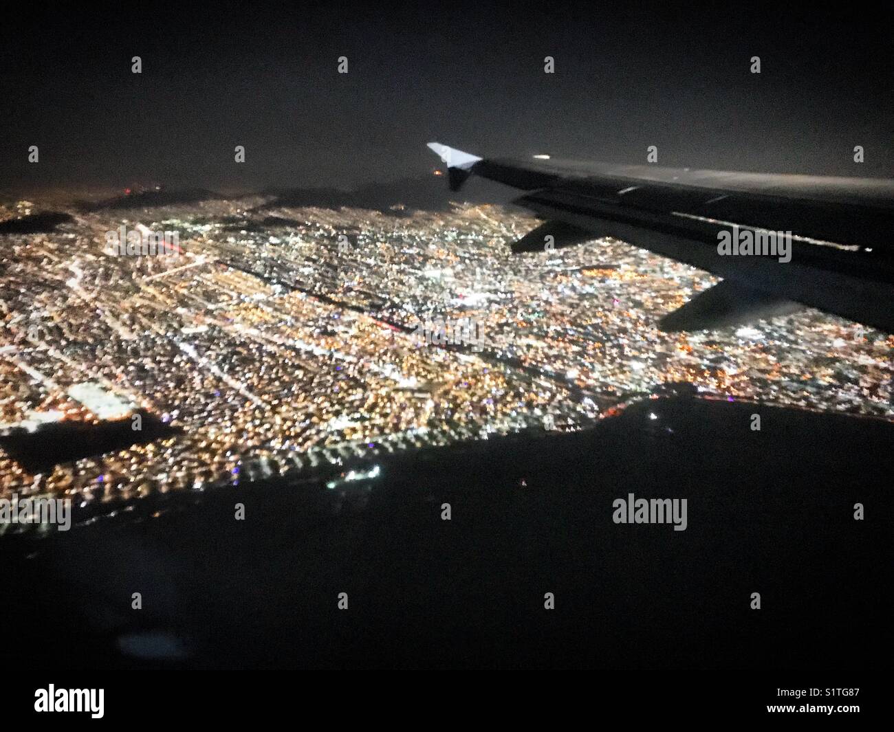 A plane flies over Mexico City, Mexico. Stock Photo
