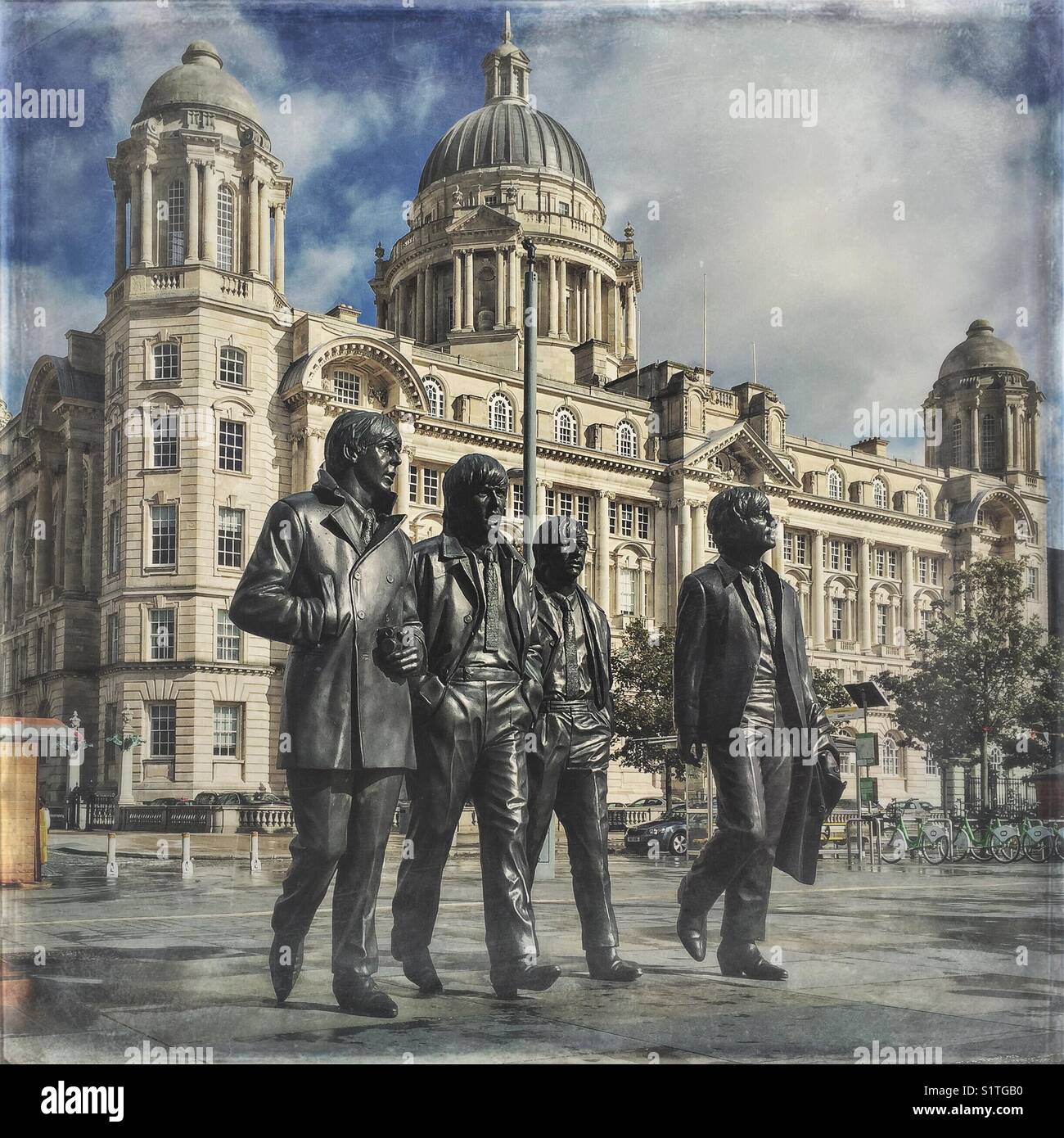 The Beatles statue in Liverpool, Merseyside, United Kingdom. Port of Liverpool building in the background - Smartphone Captured Stock Image