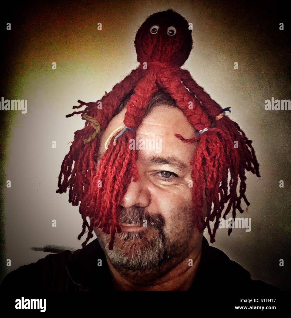 Portrait man with red octopus on head - Smartphone Captured Stock Image