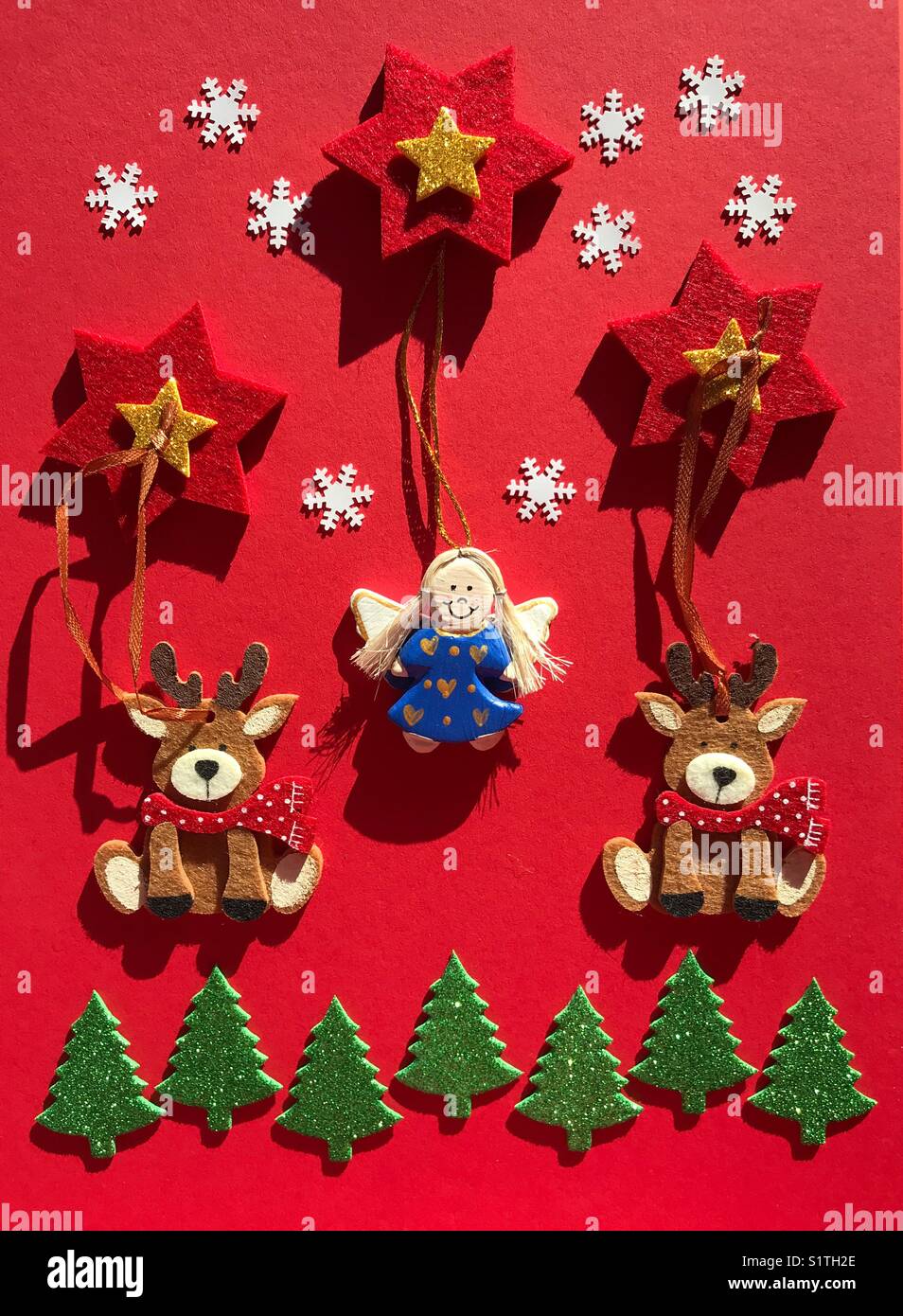 Christmas decorations, Christmas themed flatlay on red background - Smartphone Captured Stock Image