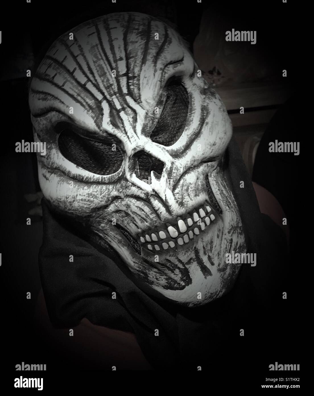 A spooky Halloween mask worn by a child. Stock Photo