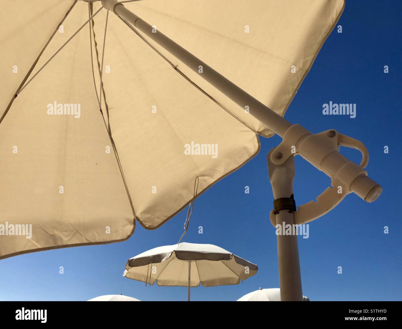 Sun umbrellas providing shade from the sun - Smartphone Captured Stock Image