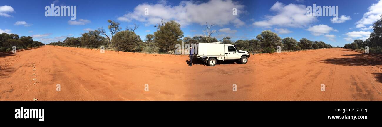 180 degrees panorama of an Australian Outback Track with a Four Wheel Drive vehicle and a female in the central area - Smartphone Captured Stock Image