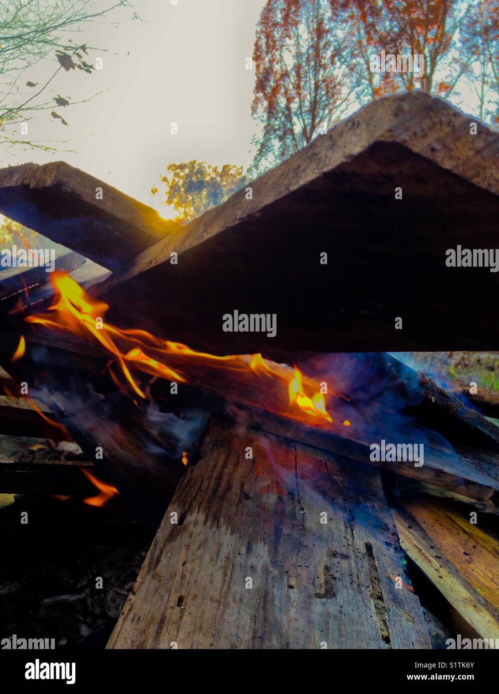 Burning planks as the sun sets - Smartphone Captured Stock Image