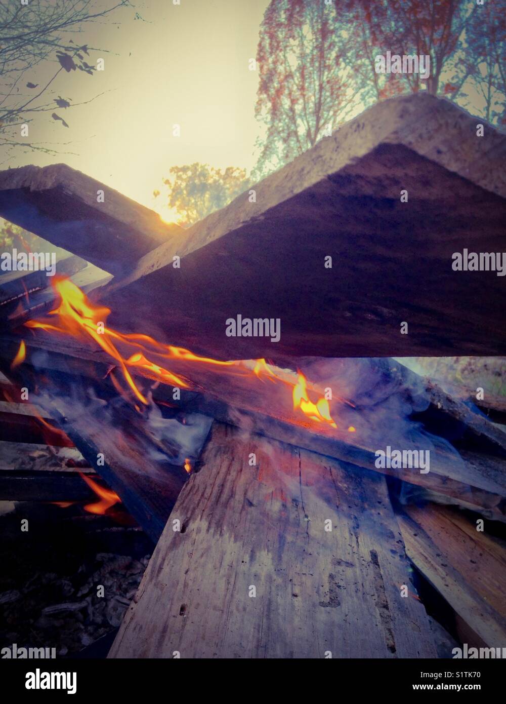 Setting sun with campfire - Smartphone Captured Stock Image