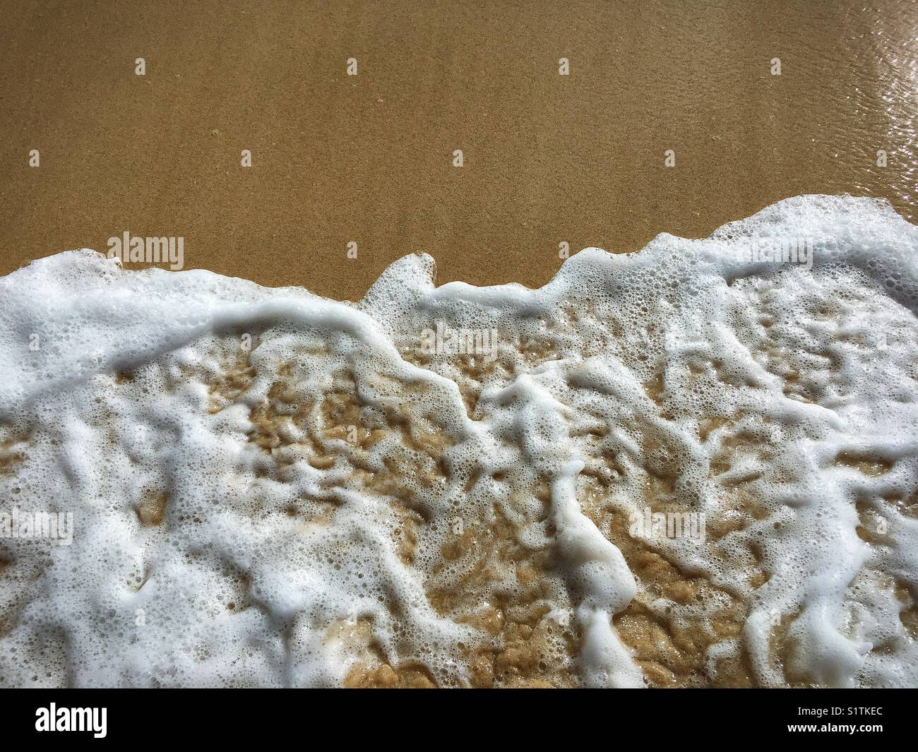 Wave foam over sand - Smartphone Captured Stock Image