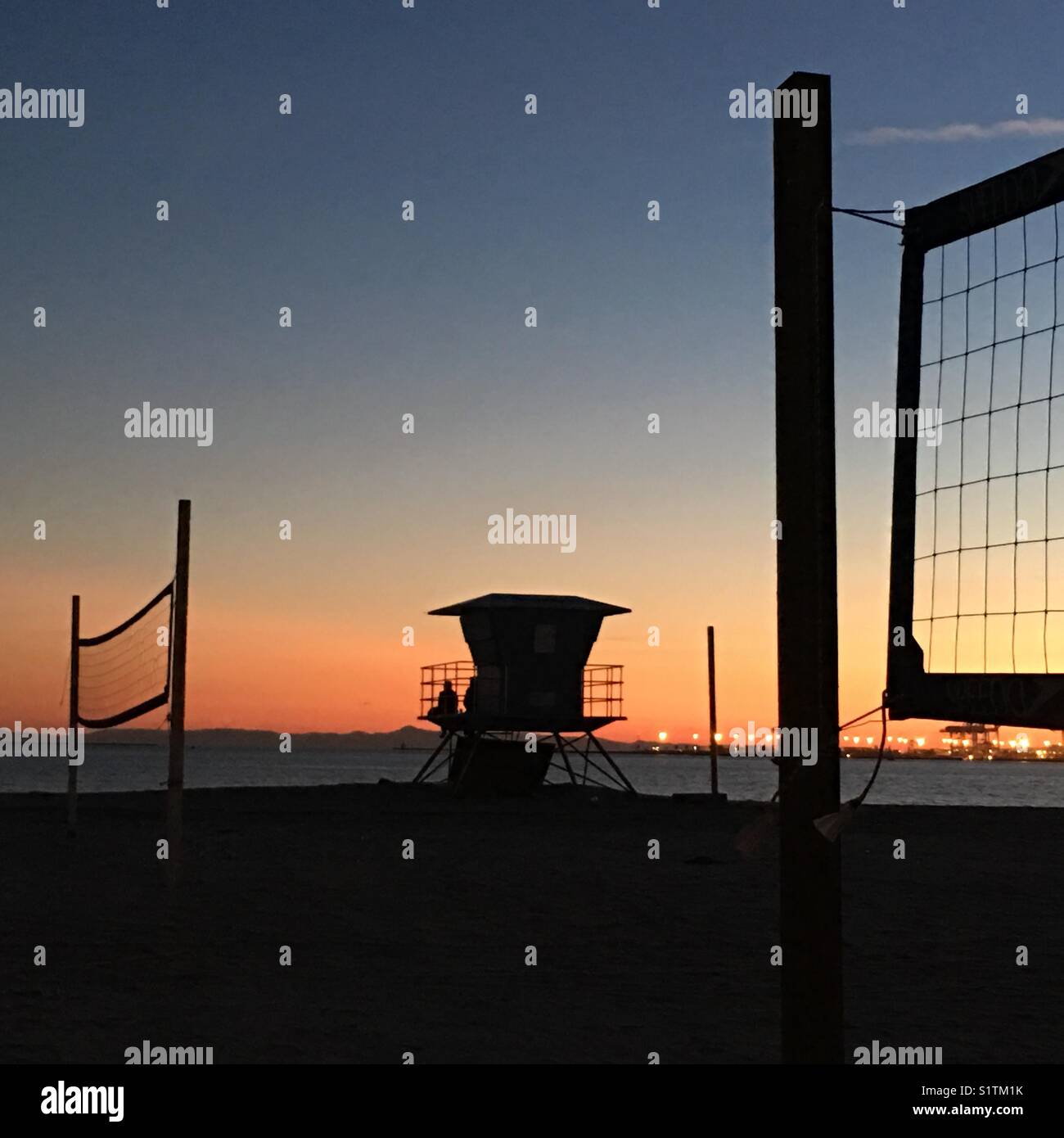 Volleyball nets and lifeguard tower at sunset on Junipero Beach in Long