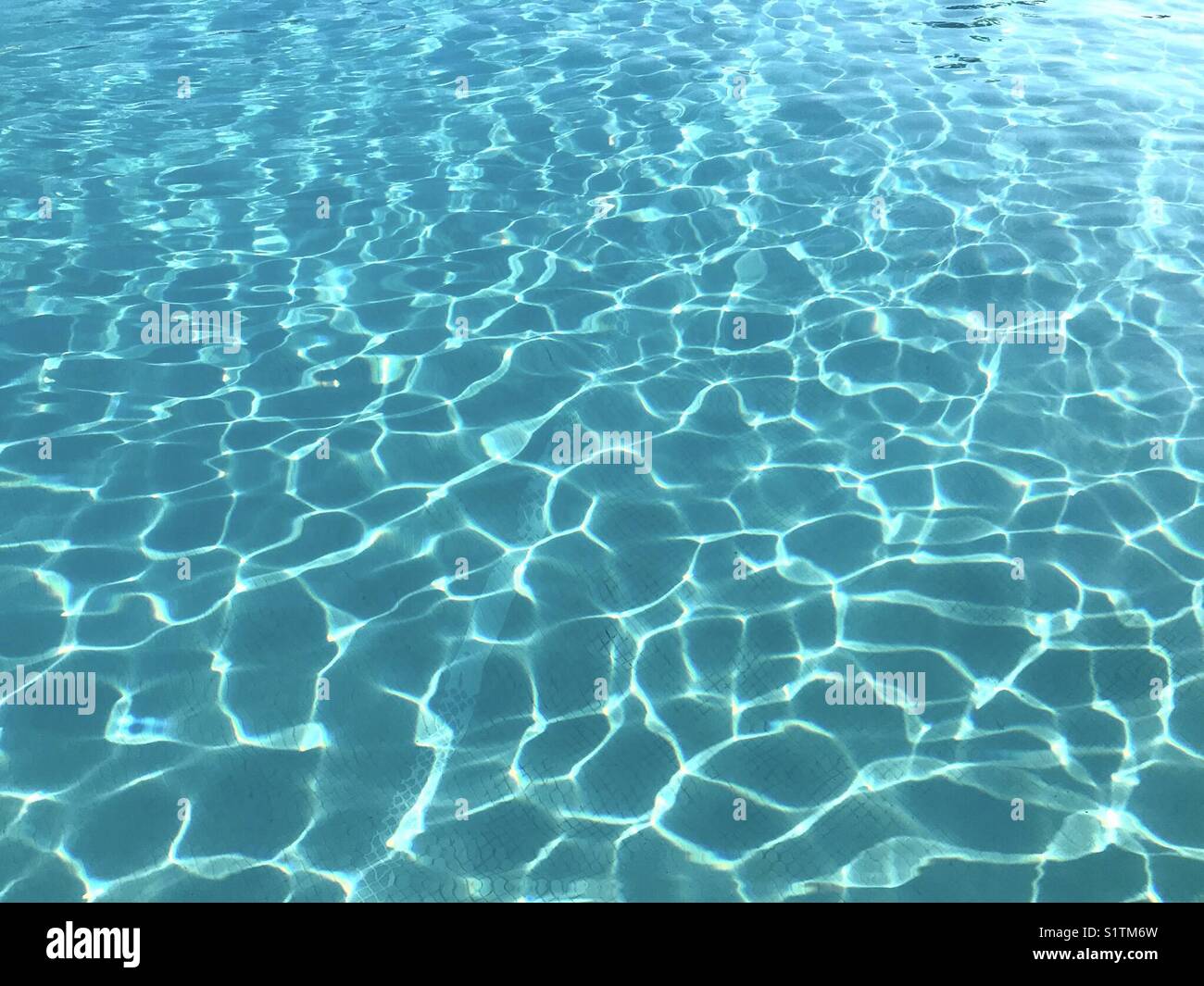 Pattern of sunlight on the water of a swimming pool - Smartphone Captured Stock Image