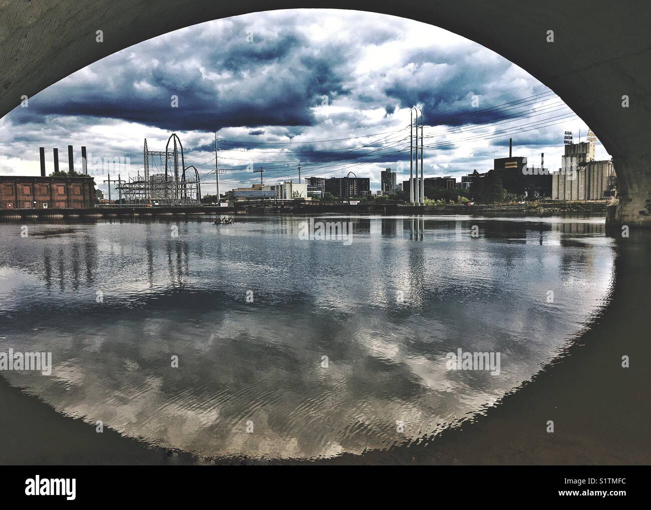 Under the bridge in Minneapolis, MN, USA. Veolia Energy Solution LLC by the Father Hennepin Bluff Park. - Smartphone Captured Stock Image