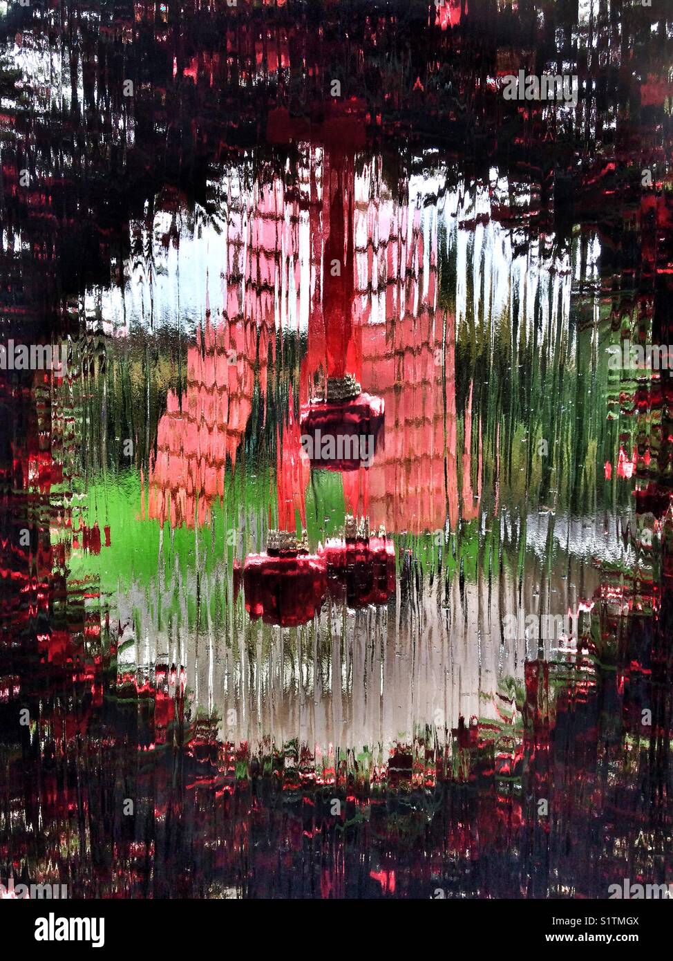 Looking Through A Christmas Wreath Hanging On A Glass Door At The