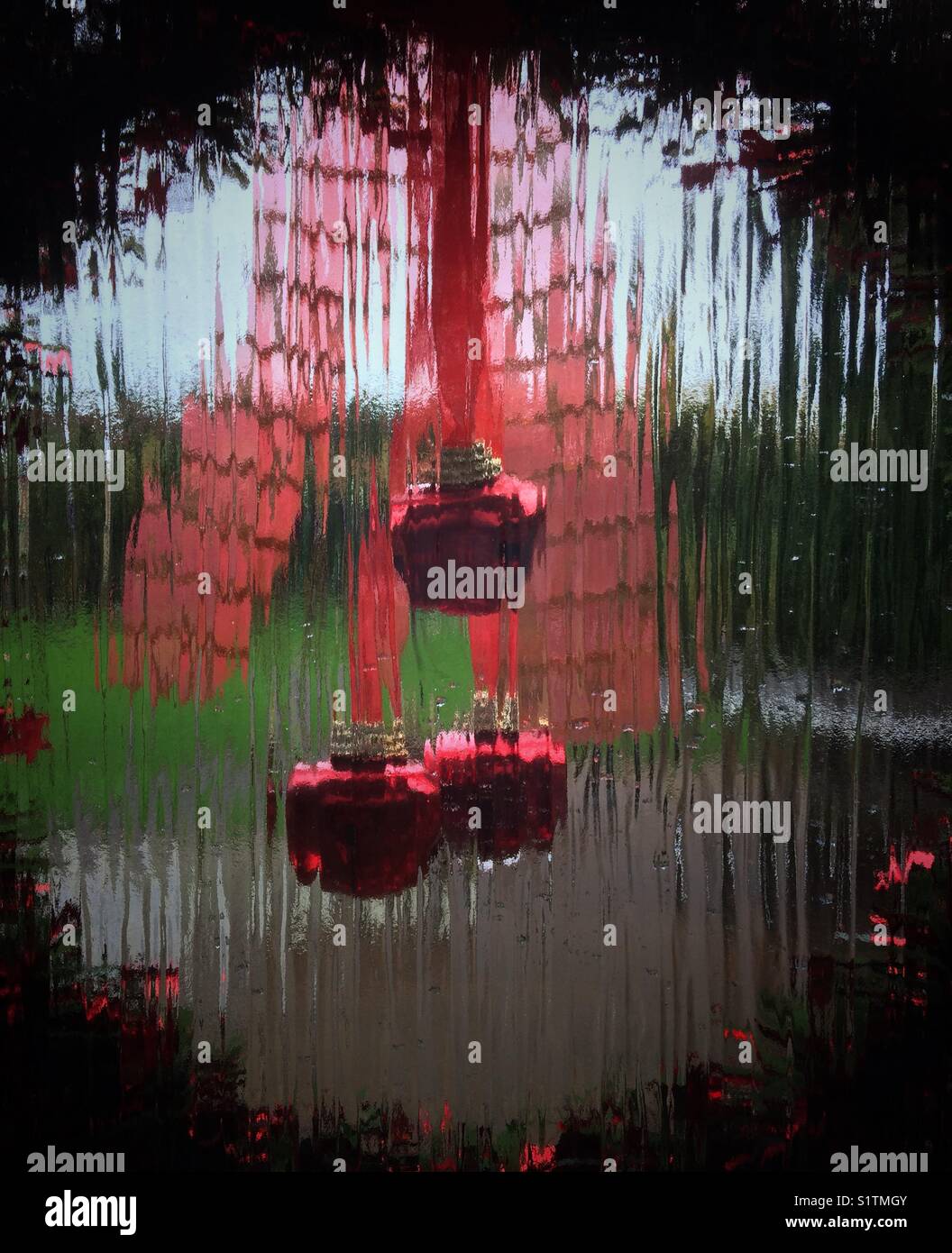 Looking Through A Christmas Wreath Hanging On A Glass Door At The