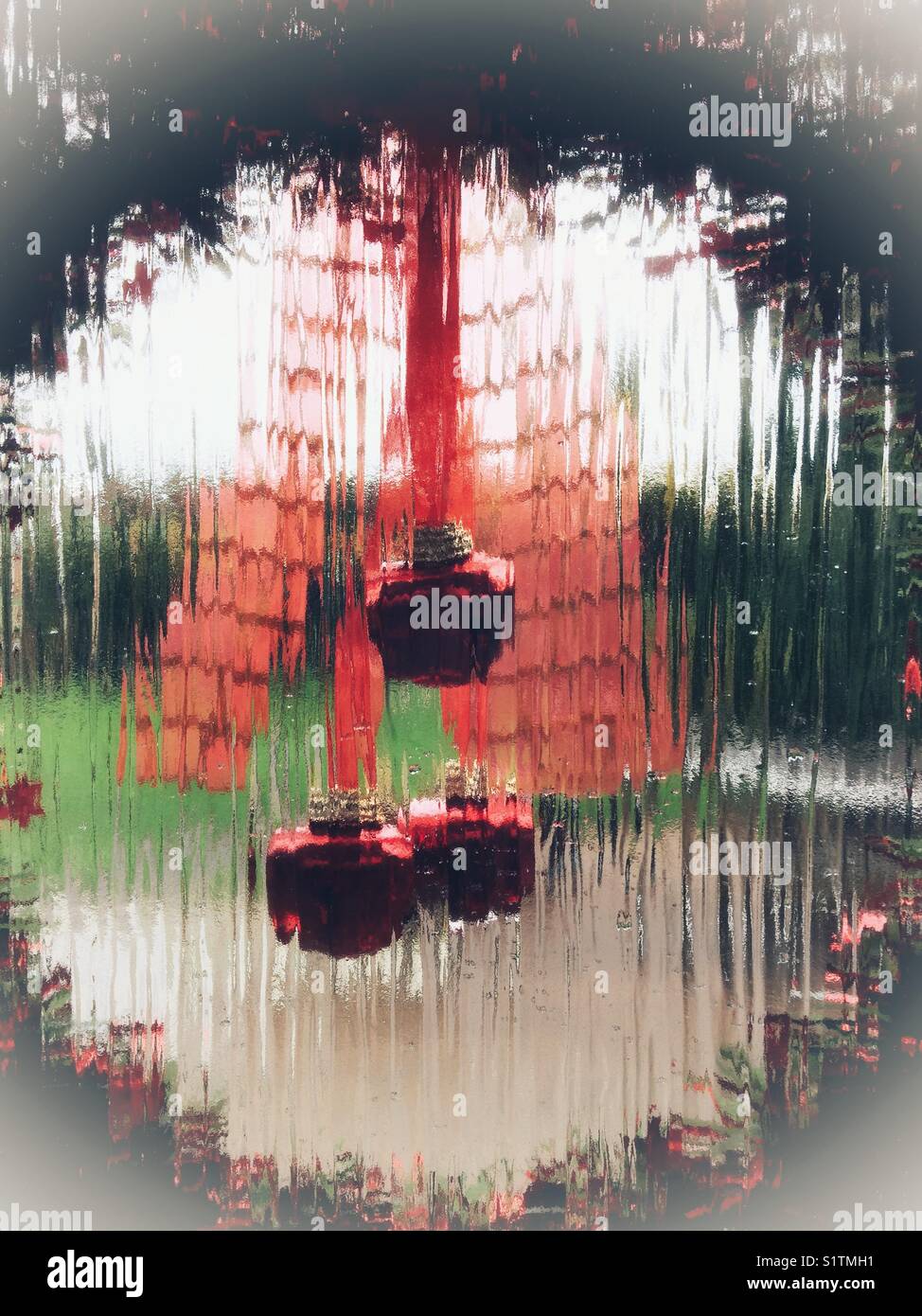 Looking Through A Christmas Wreath Hanging On A Glass Door At The