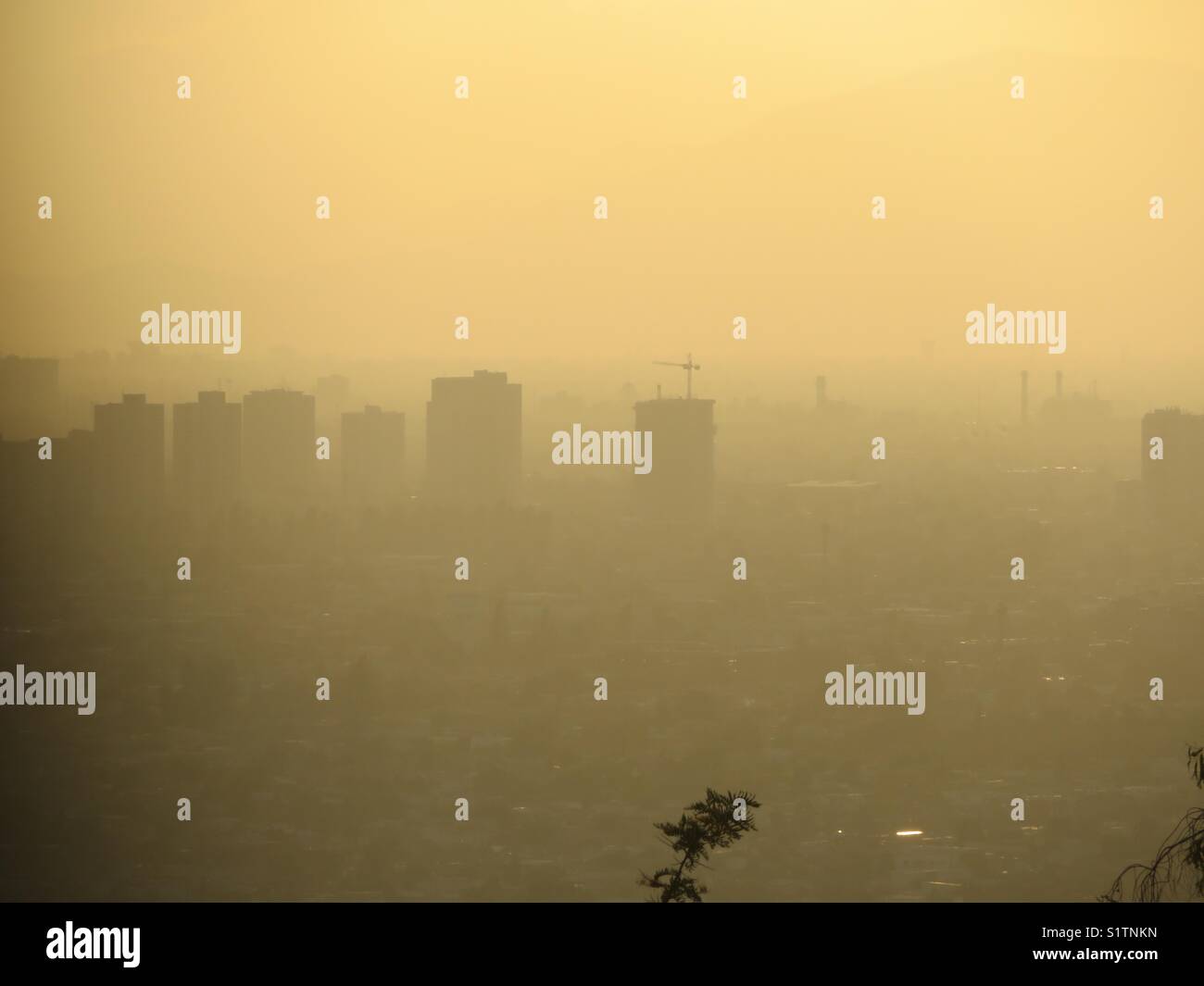This is a View from the Santiago de Chile Metropolitan park. We can see the smog covering the city. Stock Photo