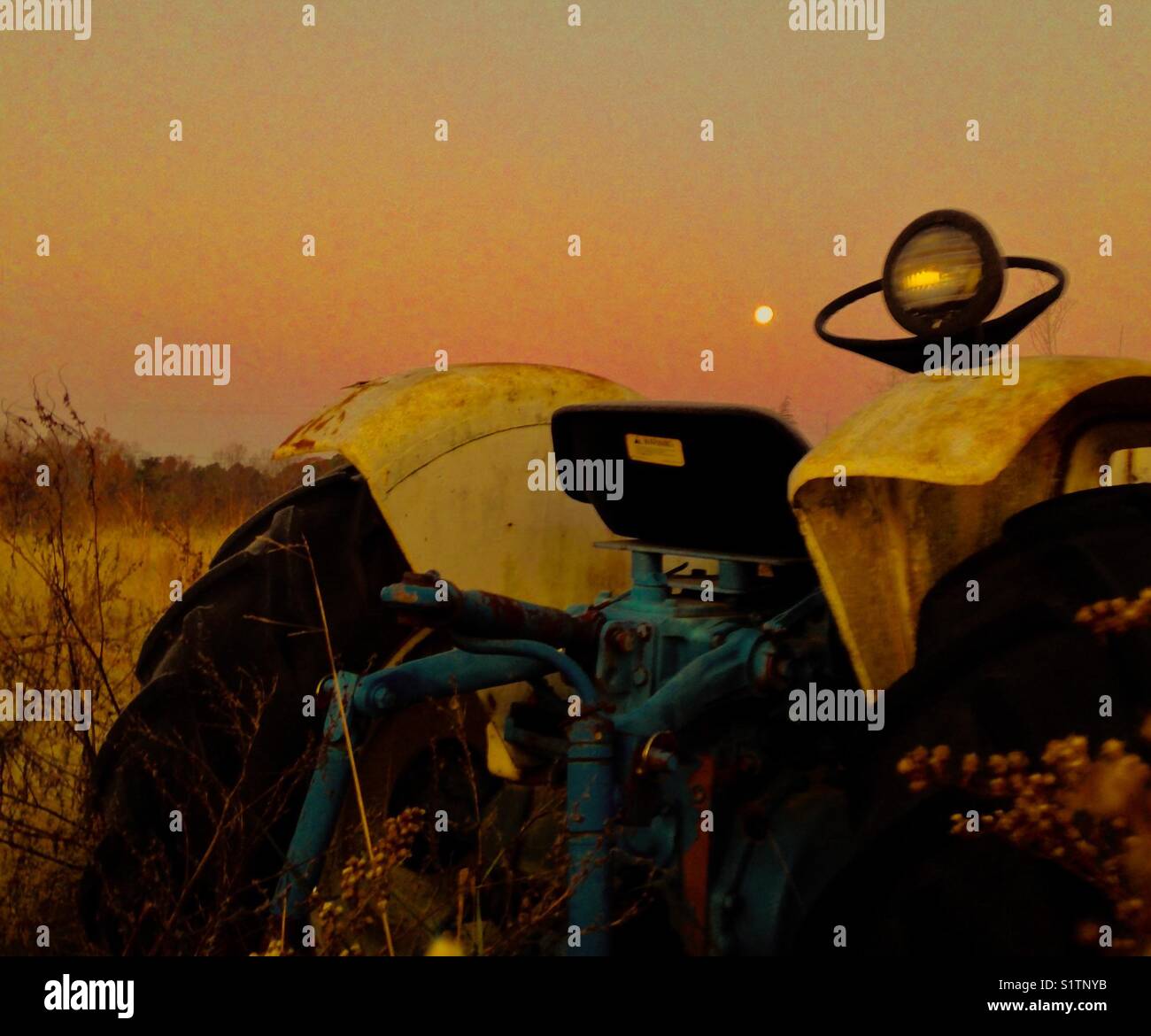 Full moon in the morning over tractor - Smartphone Captured Stock Image