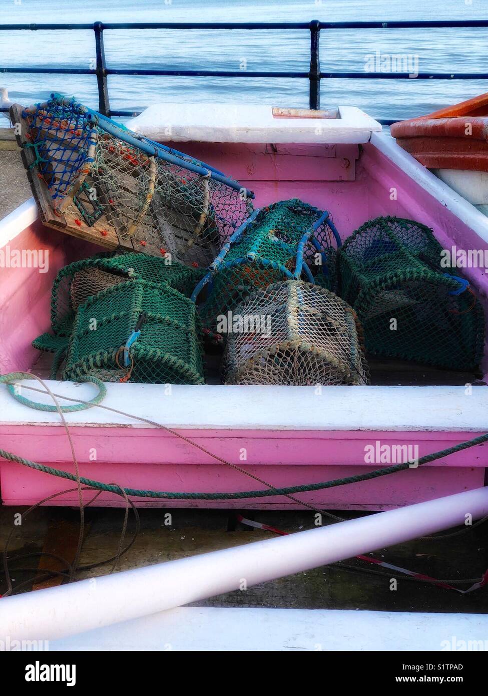 6 lobster pots in a pink fishing boat Stock Photo - Alamy