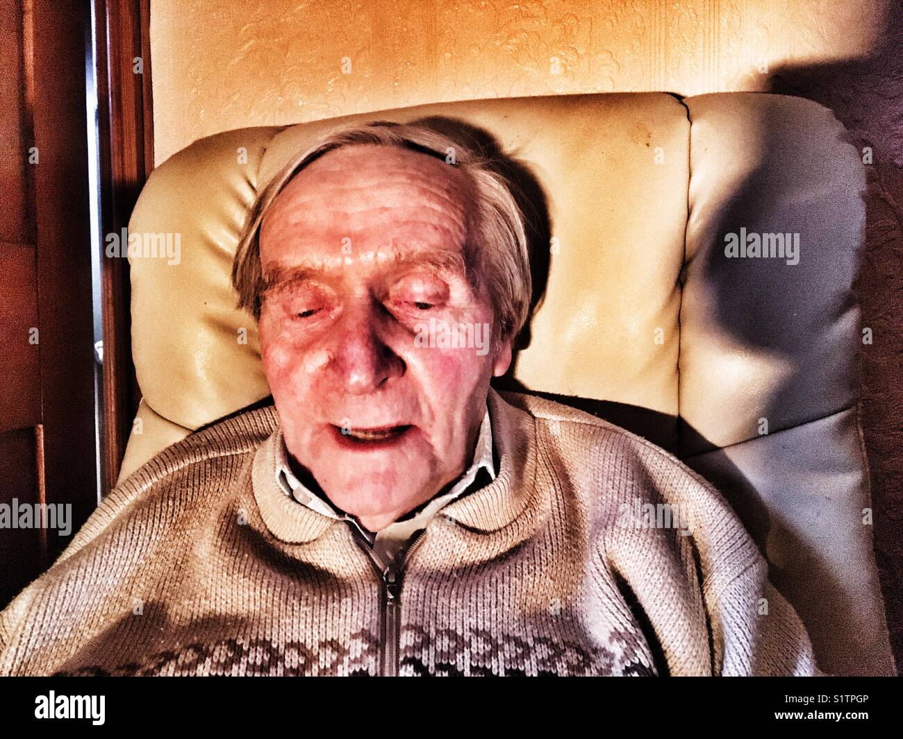 90 year old man relaxing at home - Smartphone Captured Stock Image