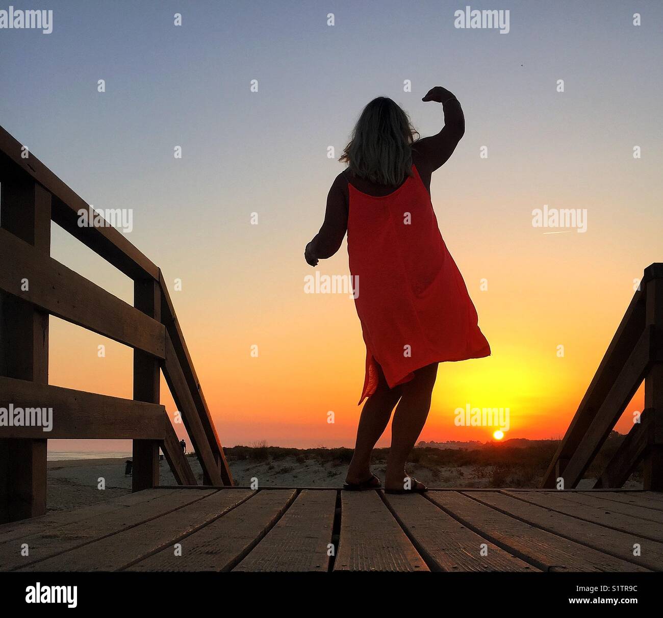 Woman dancing at sunset hi-res stock photography and images - Alamy