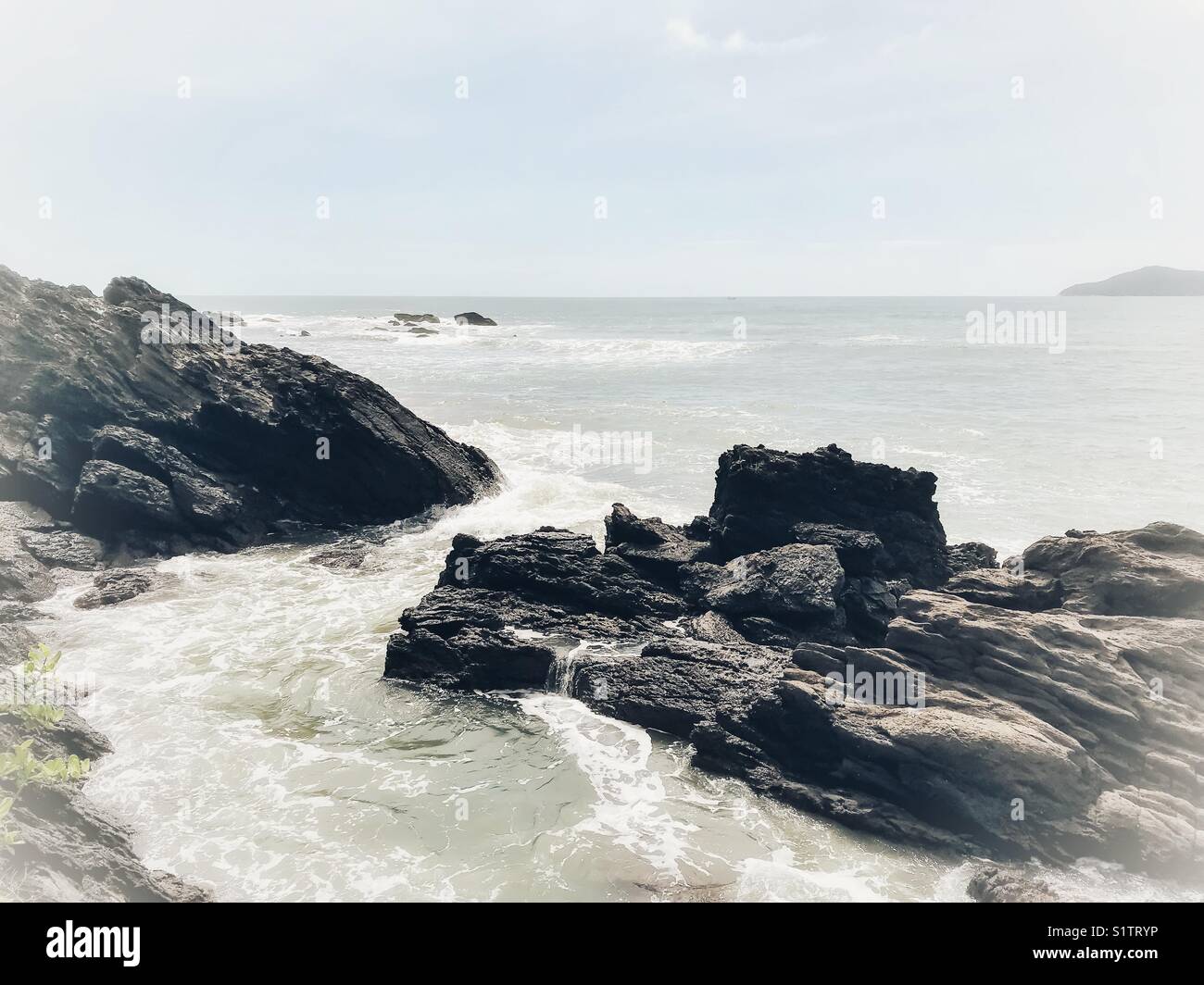 Rocks in the water against the Atlantic ocean and horizon - Smartphone Captured Stock Image